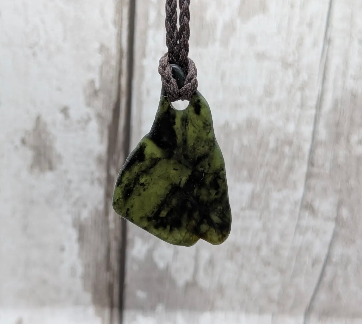 Nz tumbled Pounamu greenstone pendant with Aroha love affirmation.