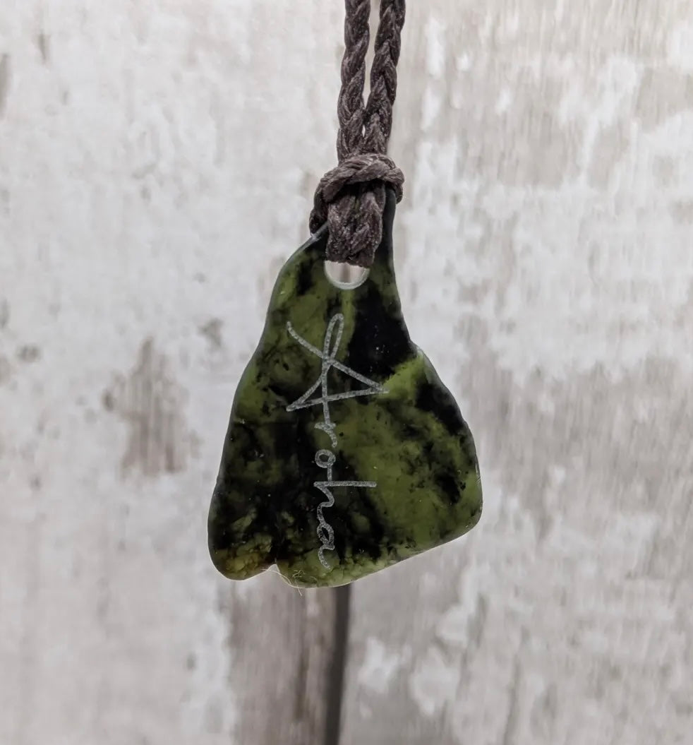 Nz tumbled Pounamu greenstone pendant with Aroha love affirmation.