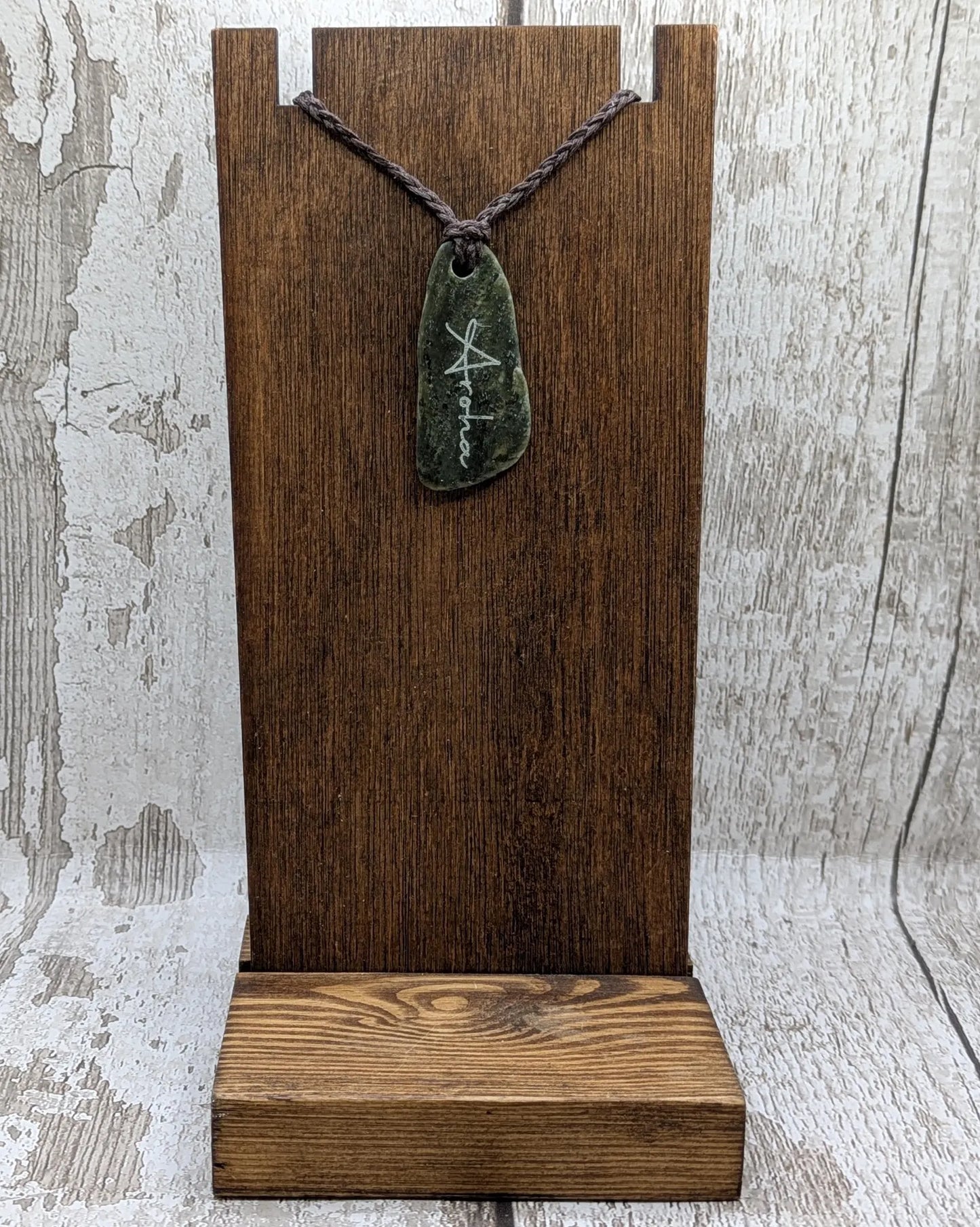 Nz tumble polished Pounamu jade pendant with Aroha love affirmation.