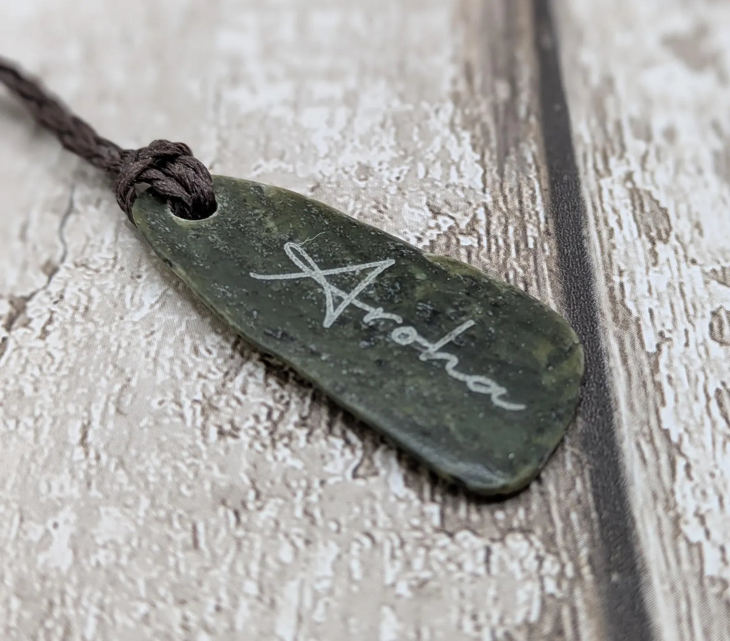 Nz tumble polished Pounamu jade pendant with Aroha love affirmation.