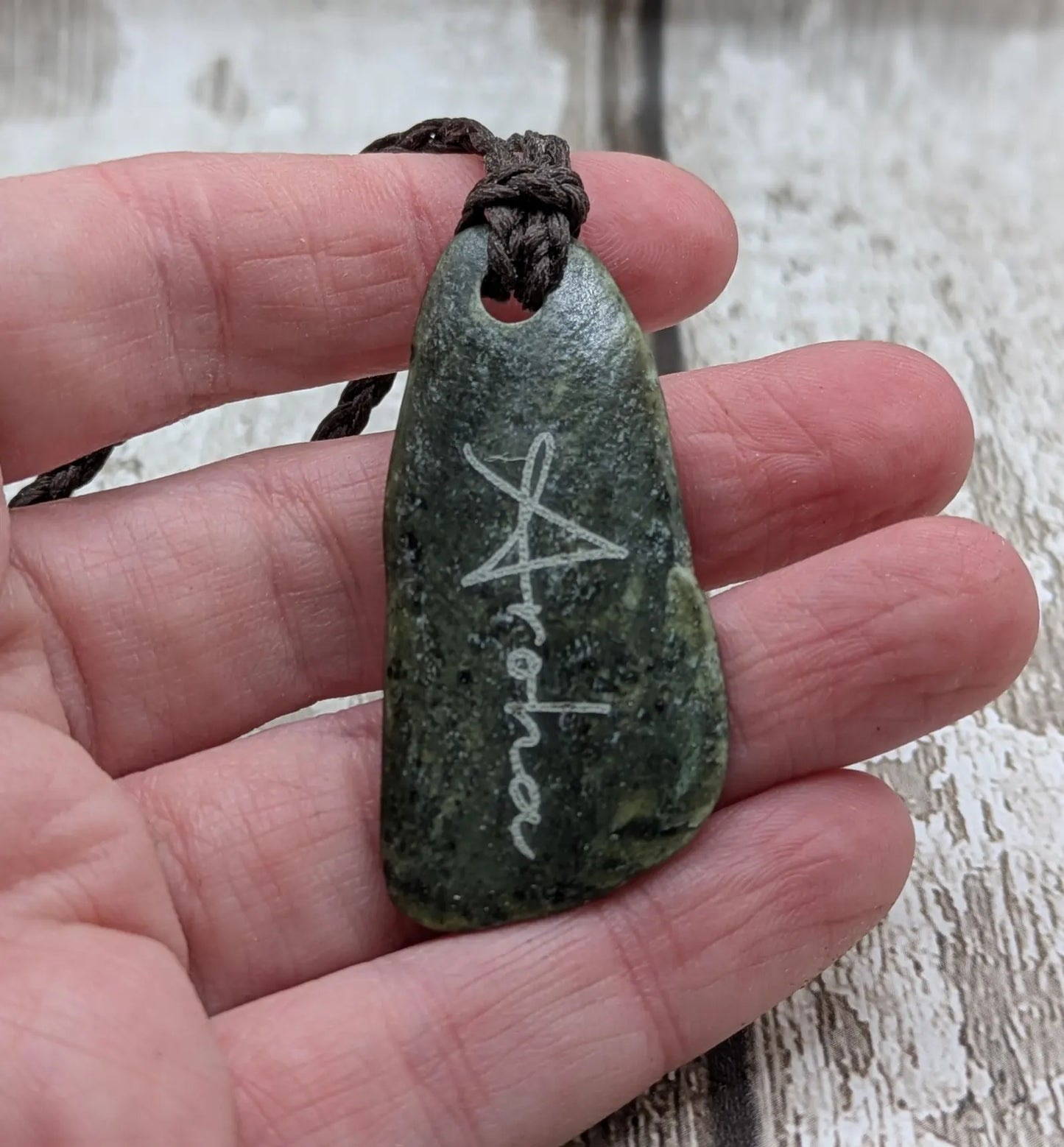 Nz tumble polished Pounamu jade pendant with Aroha love affirmation.