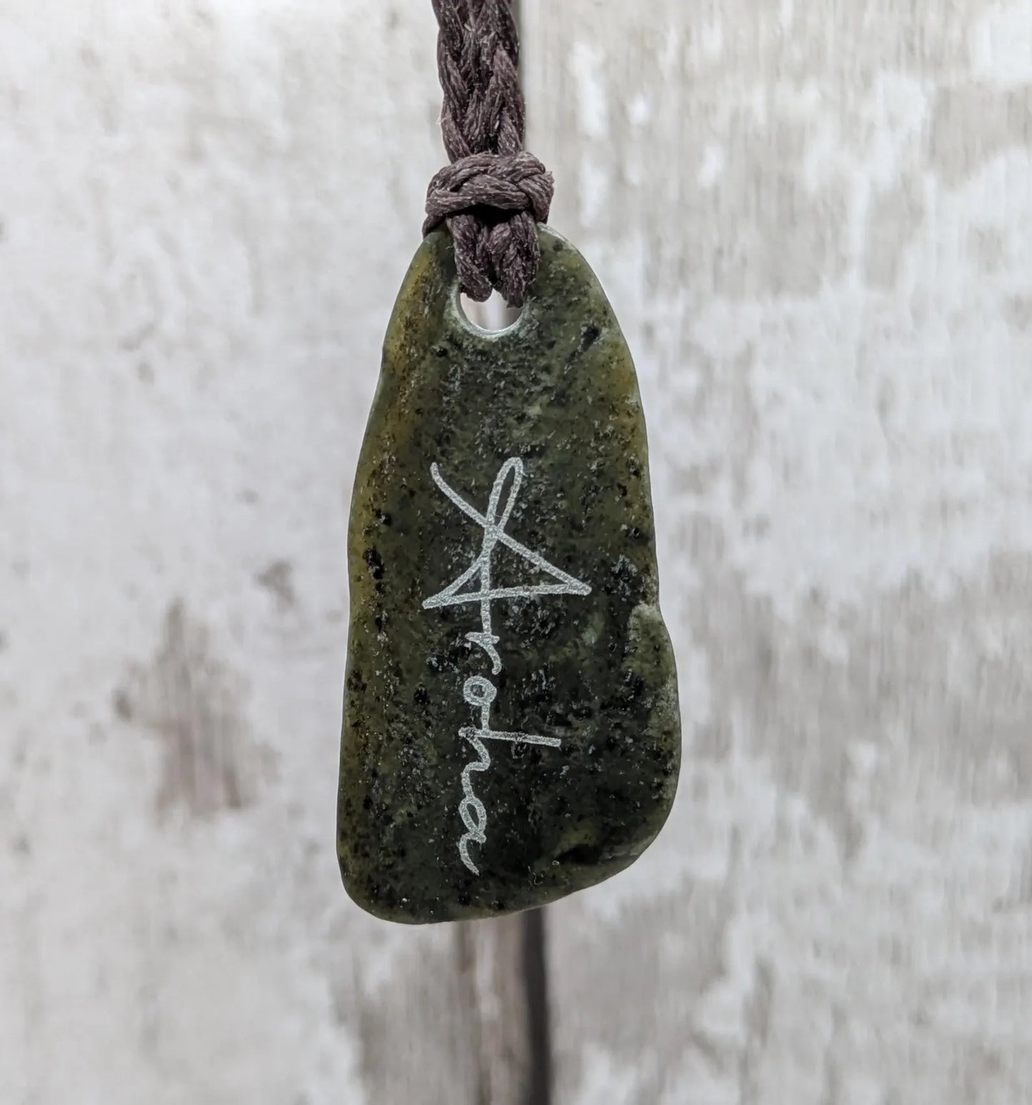 Nz tumble polished Pounamu jade pendant with Aroha love affirmation.