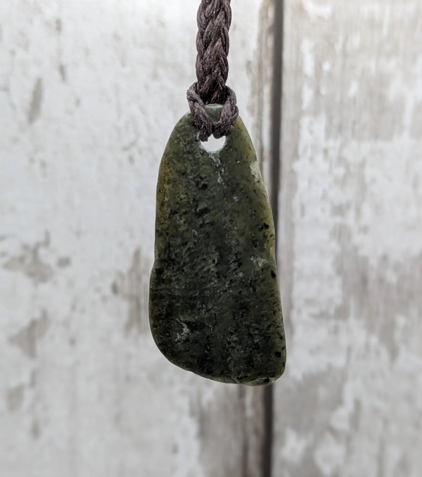 Nz tumble polished Pounamu jade pendant with Aroha love affirmation.