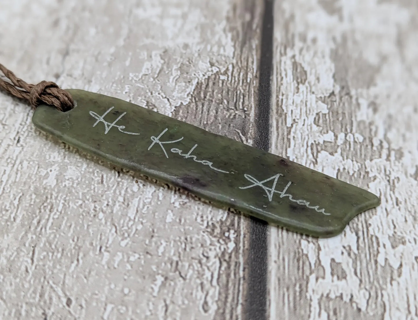 Tumble polished New Zealand Pounamu greenstone jade slice pendant with I am strong in te Reo Māori