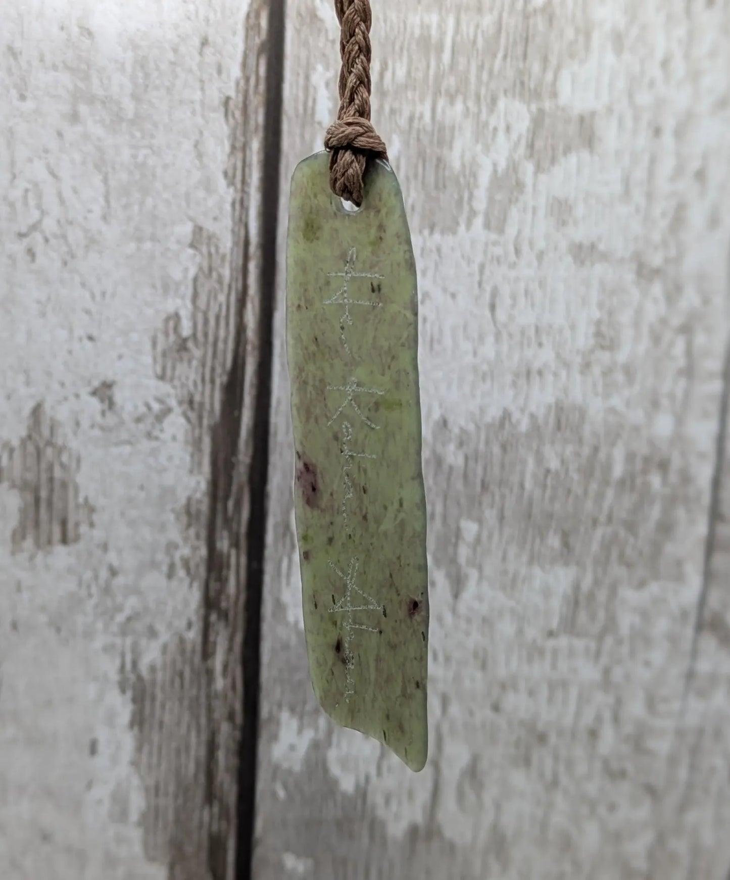 Tumble polished New Zealand Pounamu greenstone jade slice pendant with I am strong in te Reo Māori
