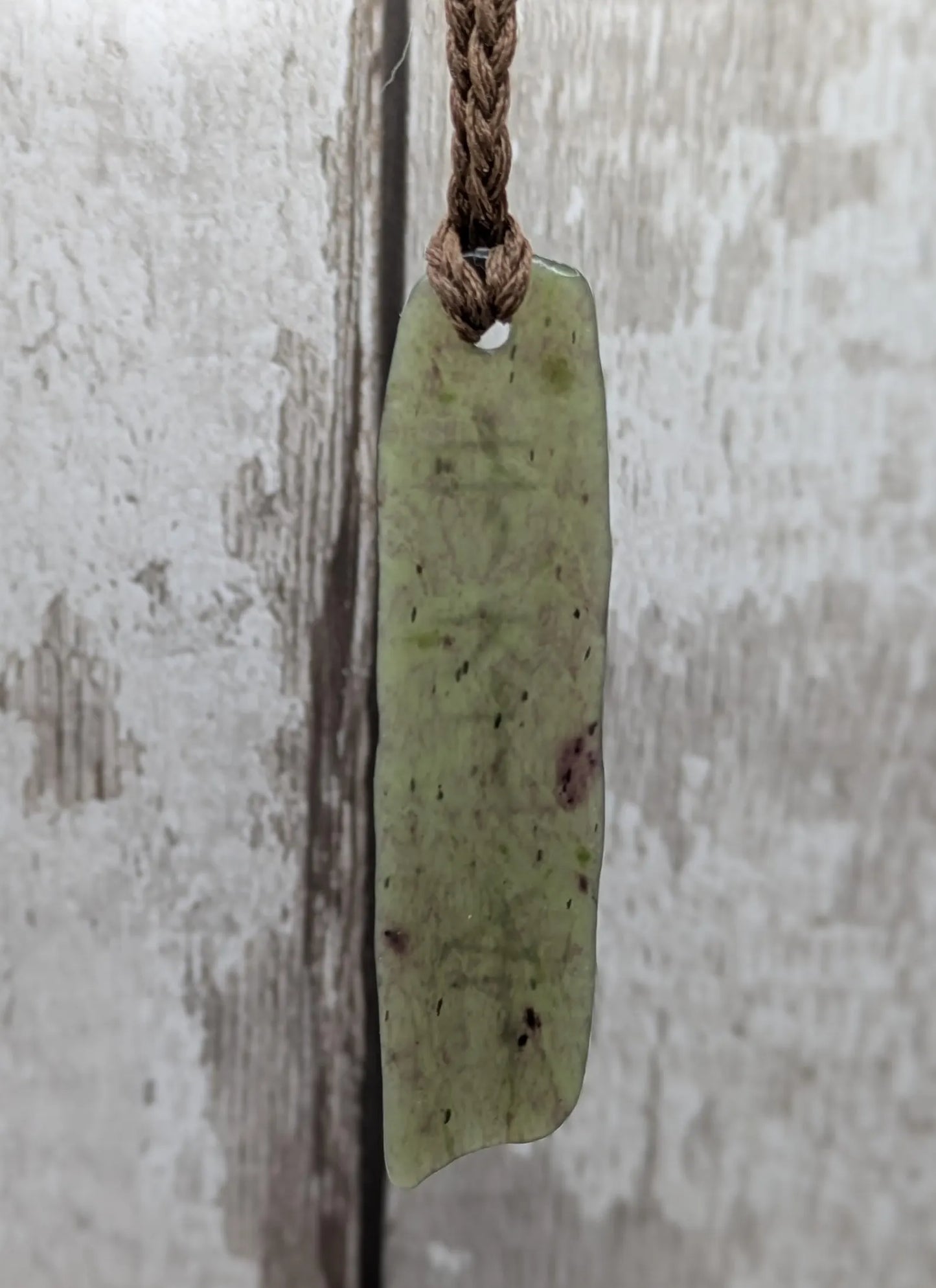 Tumble polished New Zealand Pounamu greenstone jade slice pendant with I am strong in te Reo Māori