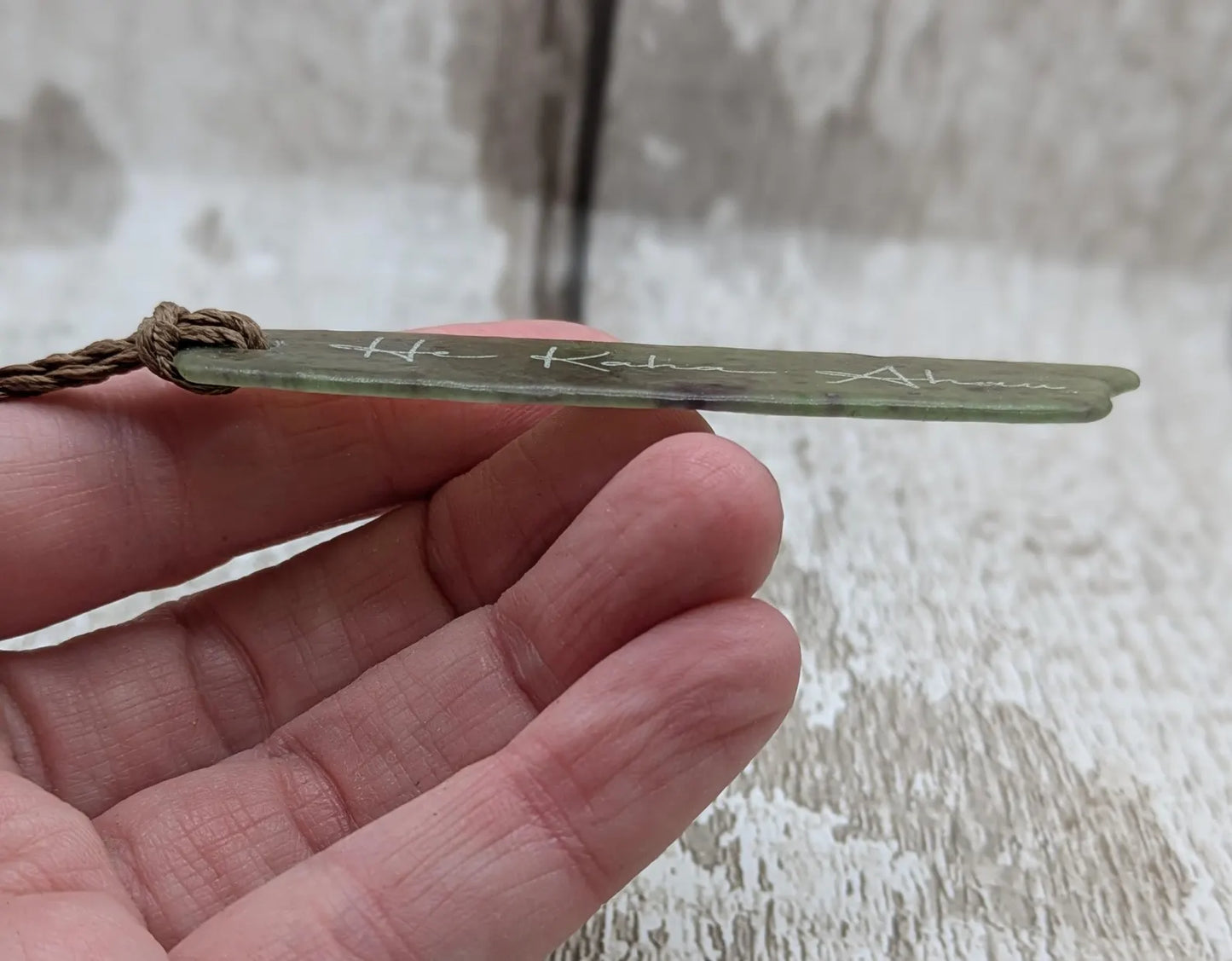 Tumble polished New Zealand Pounamu greenstone jade slice pendant with I am strong in te Reo Māori