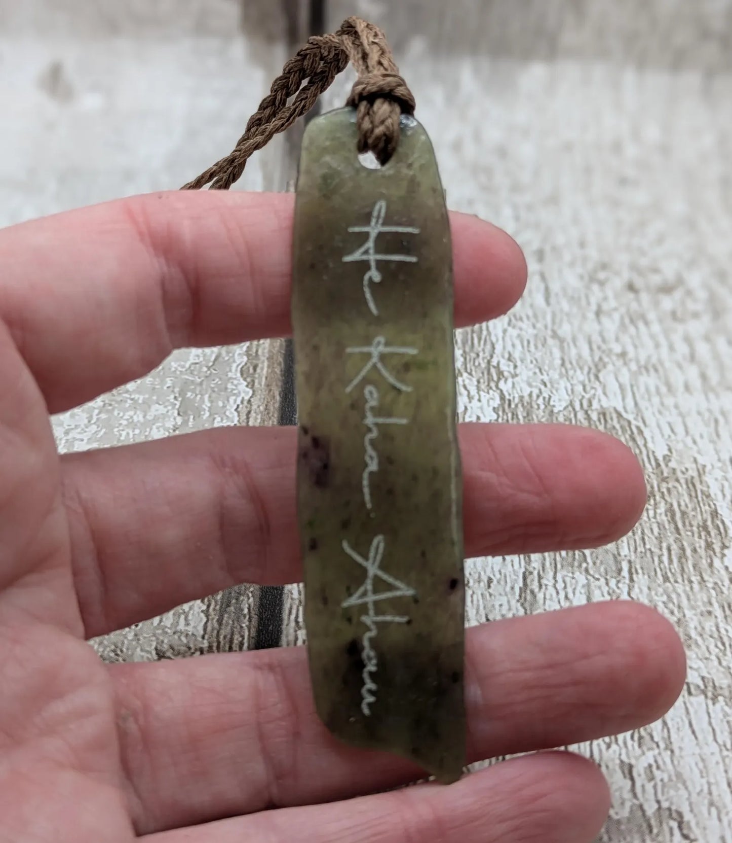 Tumble polished New Zealand Pounamu greenstone jade slice pendant with I am strong in te Reo Māori