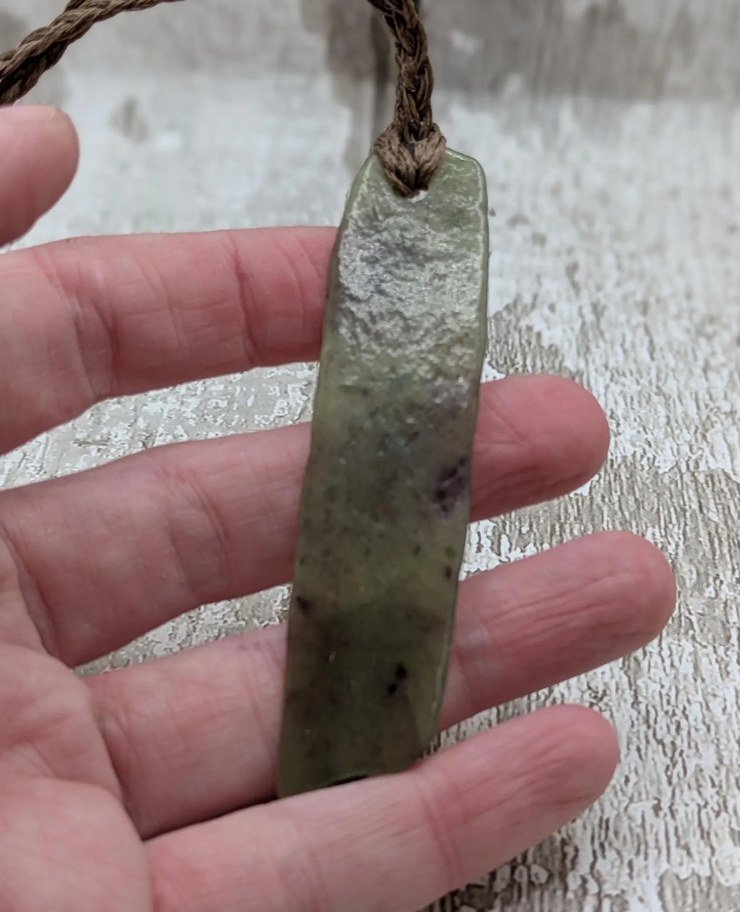 Tumble polished New Zealand Pounamu greenstone jade slice pendant with I am strong in te Reo Māori