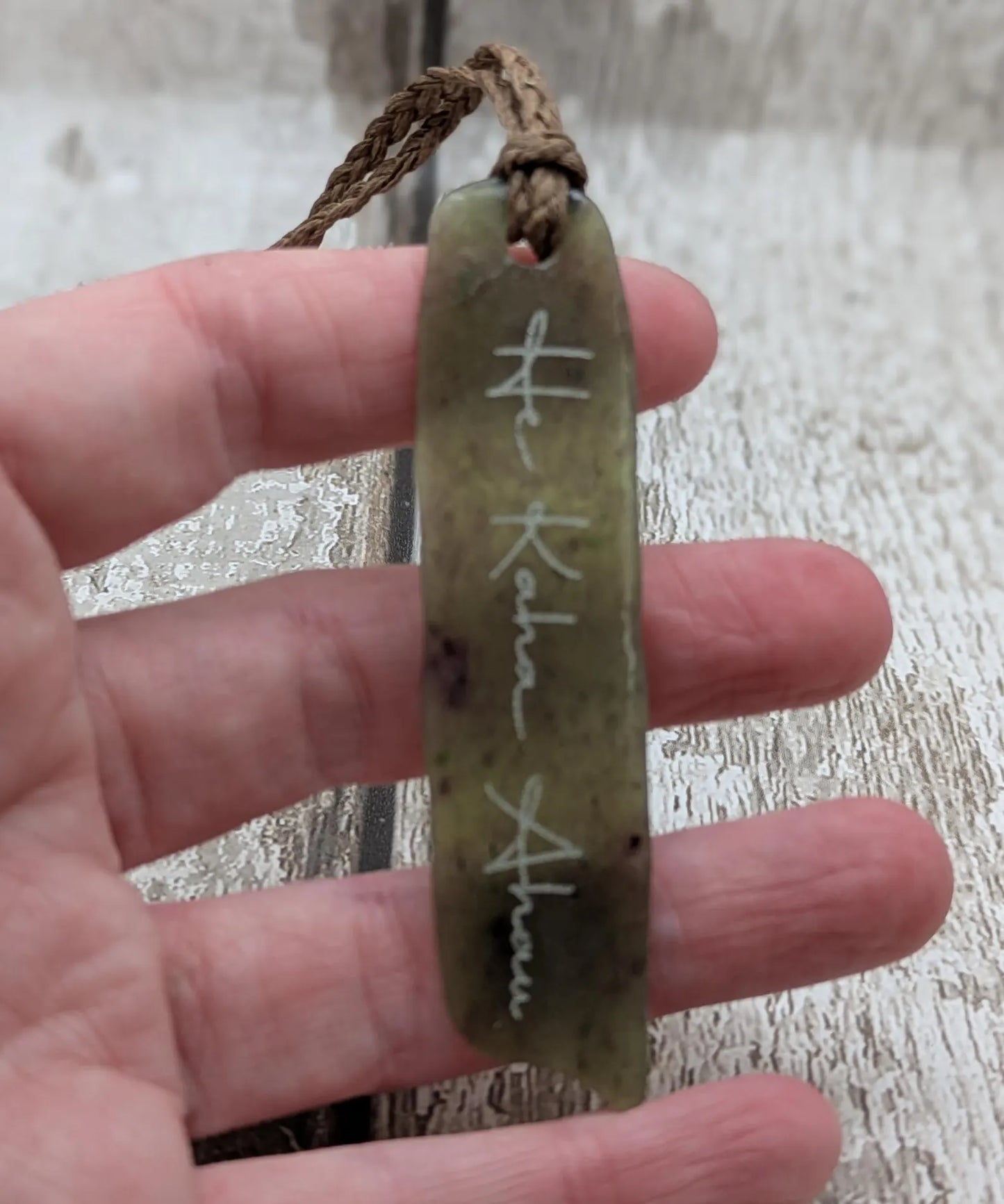 Tumble polished New Zealand Pounamu greenstone jade slice pendant with I am strong in te Reo Māori