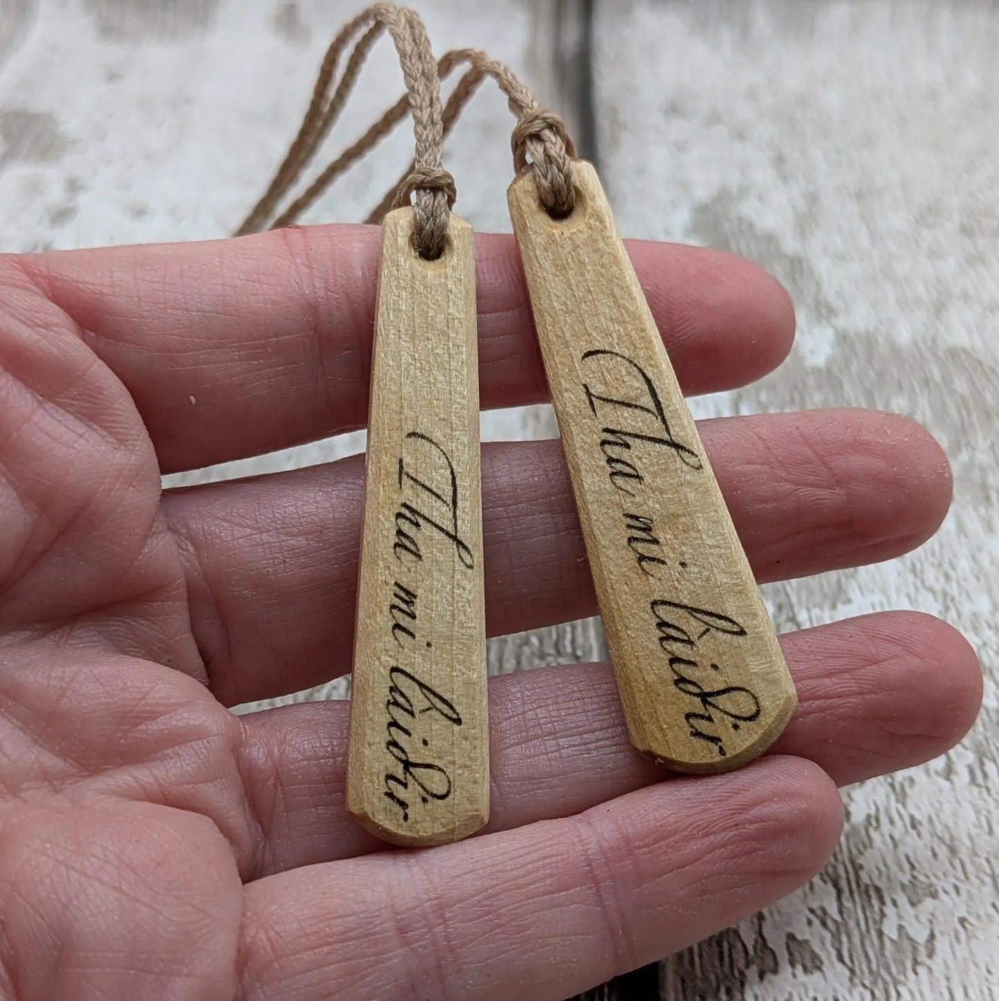 Lime wood Scots Gaelic Tha Mi Láidir, I am strong roimata drop pendant.