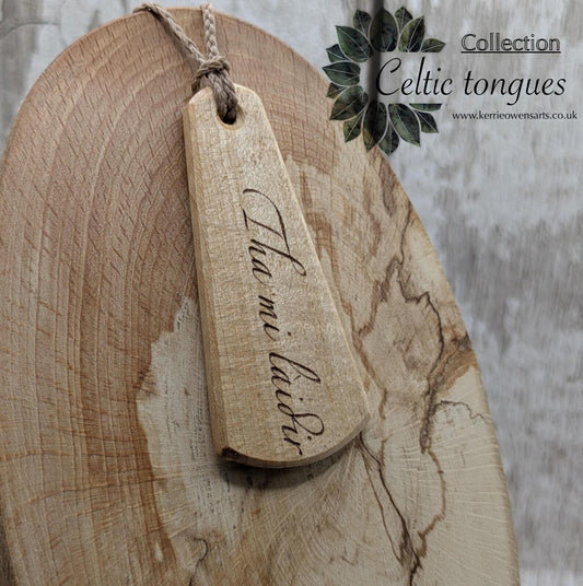 Lime wood Scots Gaelic roimata pendant. Tha mi làidir, I am strong.