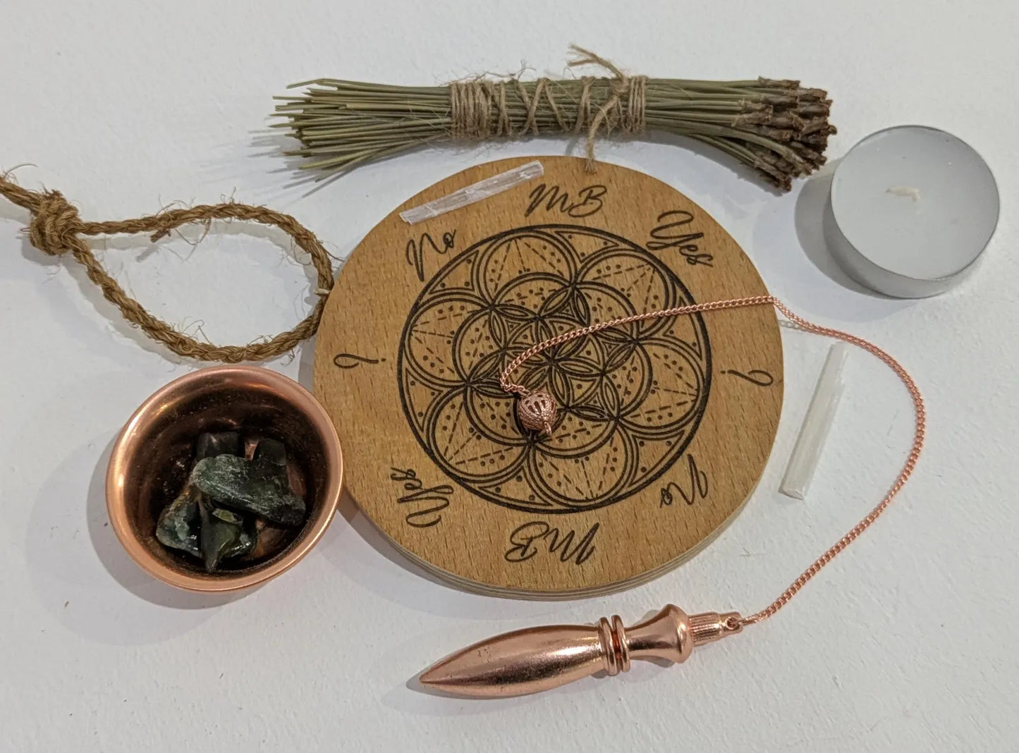 Recycled ply wood pendulum dowsing board with geometric design.