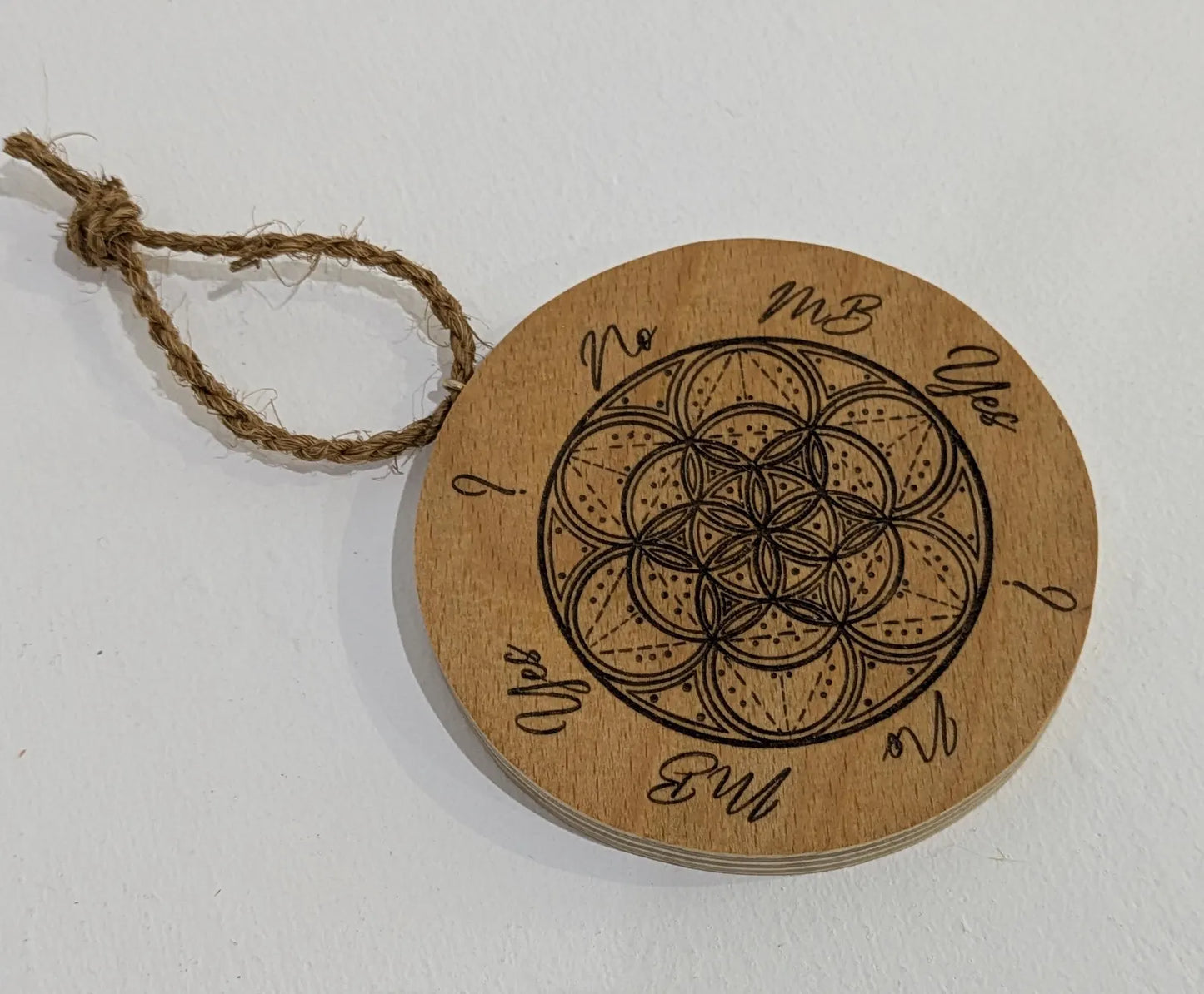 Recycled ply wood pendulum dowsing board with geometric design.