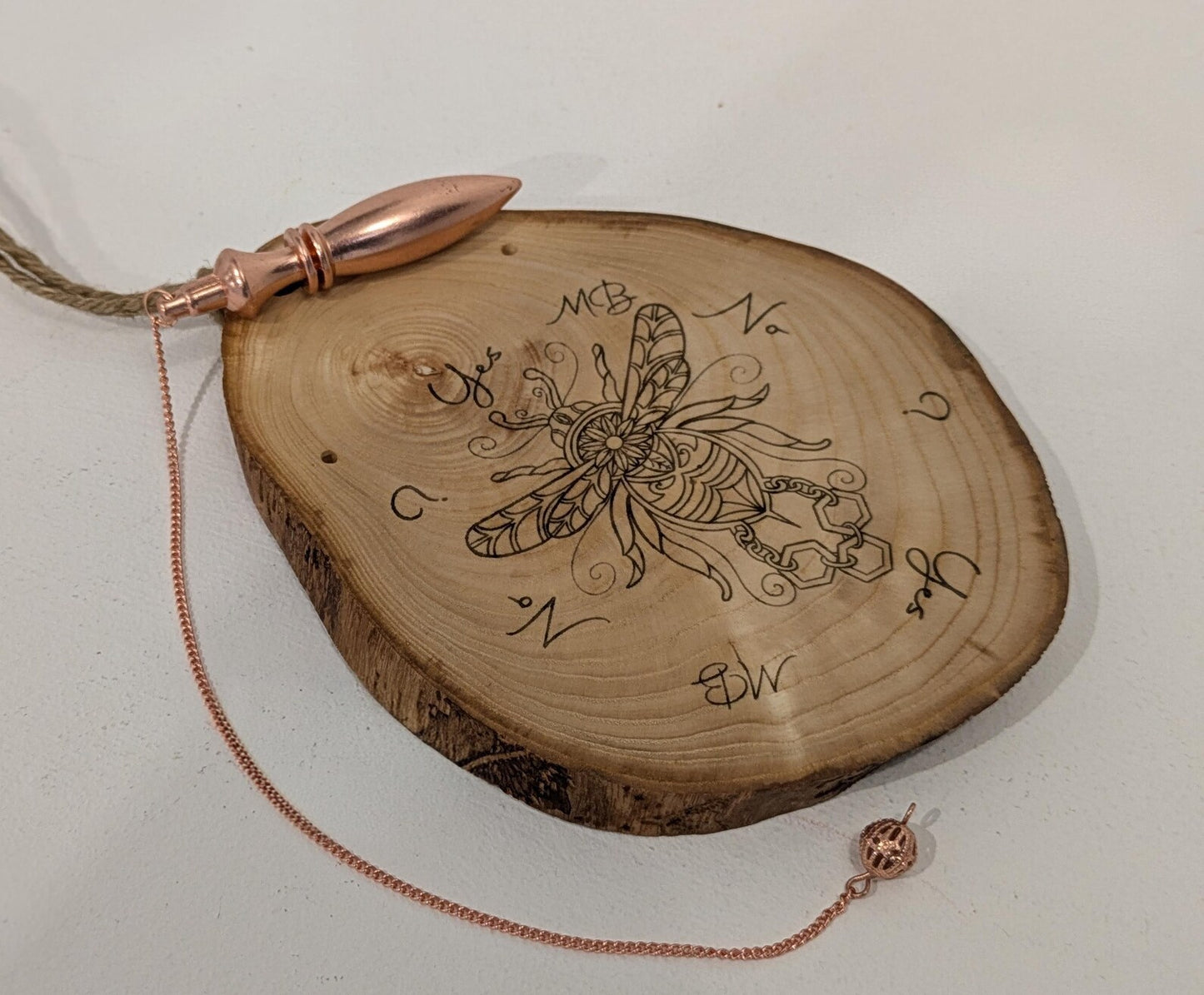 Ash wood hanging gilded bumble bee laser printed pendulum board.
