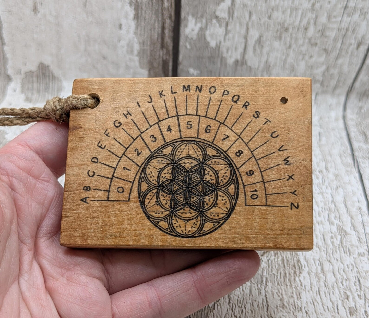 Alder wood mini pocket sized alphabet dowsing pendulum board.