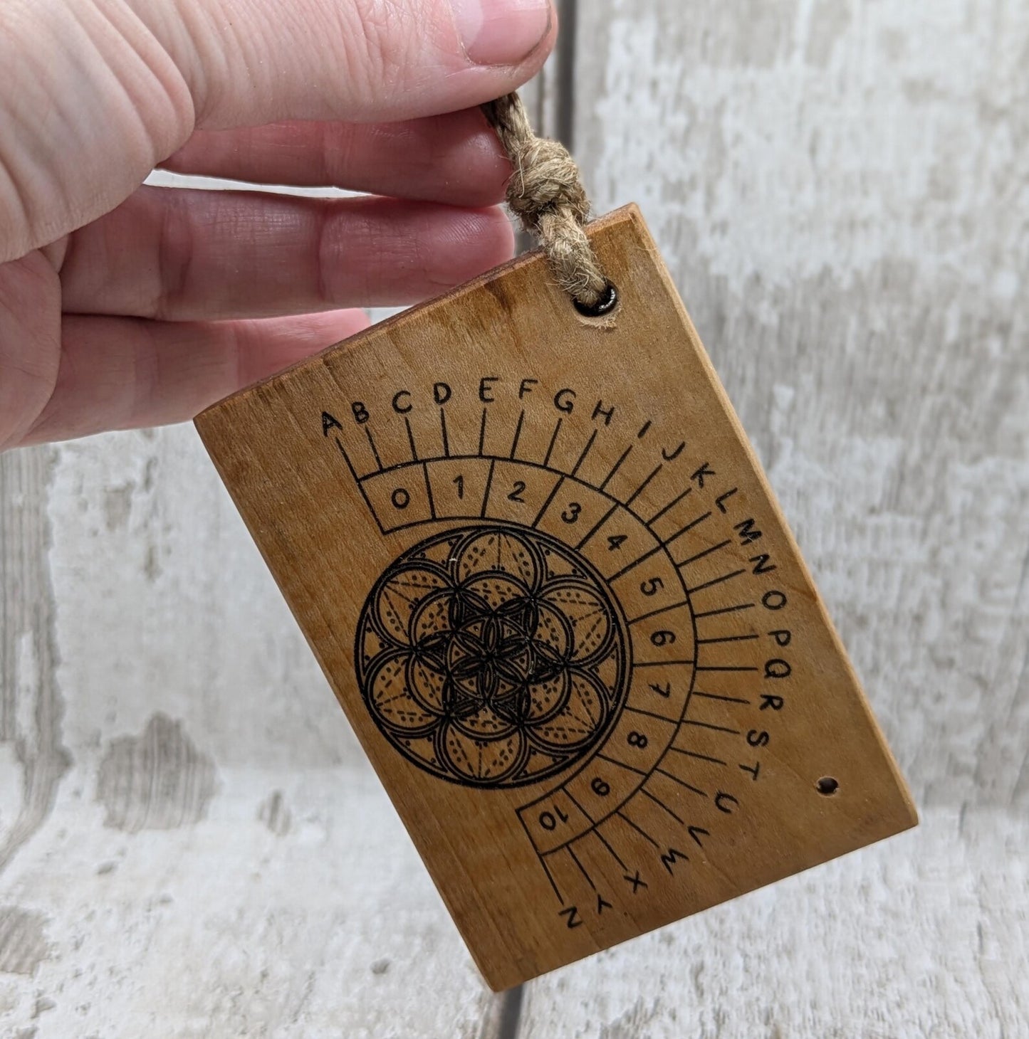 Alder wood mini pocket sized alphabet dowsing pendulum board.