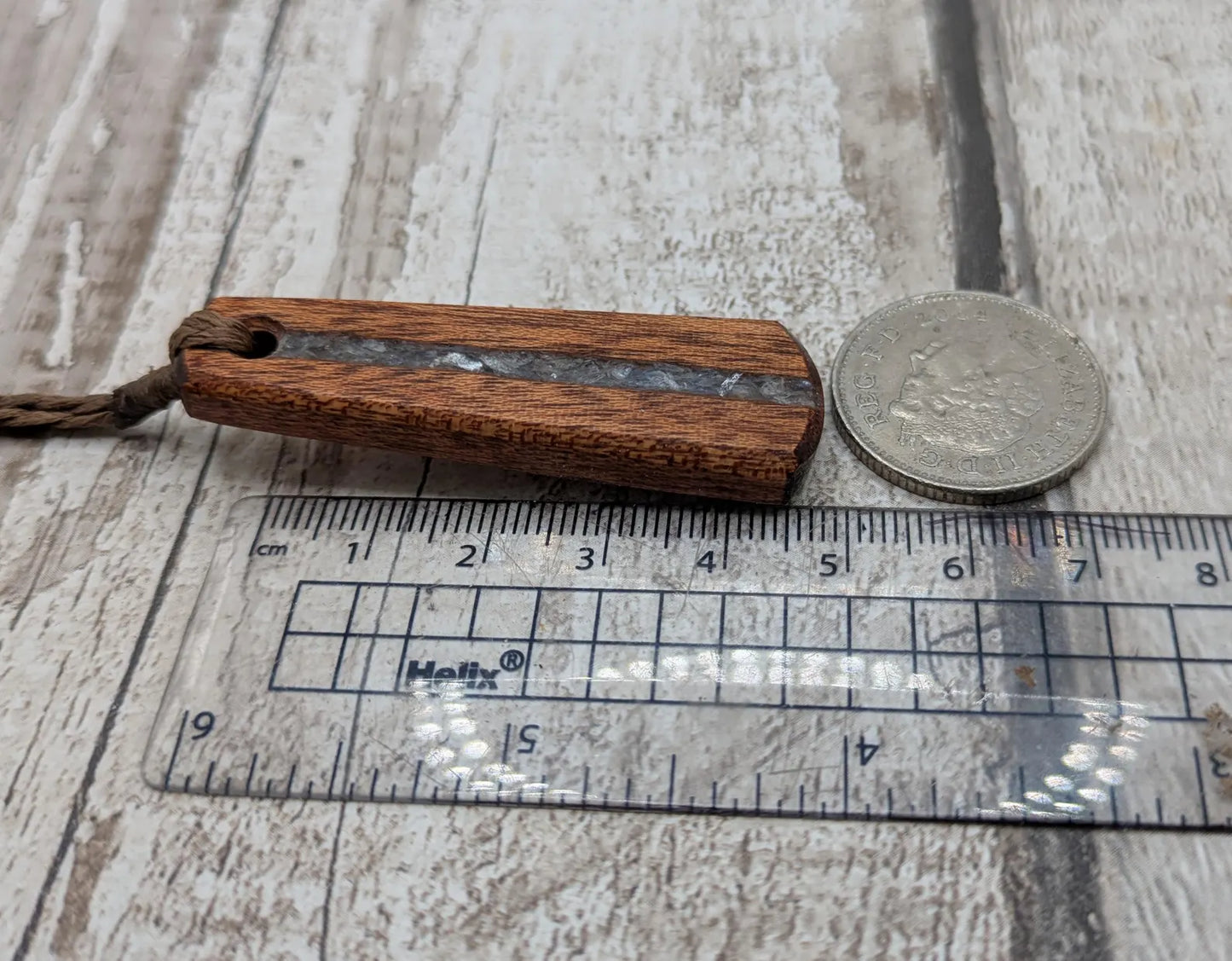 Made to order Sepele mahogany roimata teardrop pendant with blue kyanite inlay.