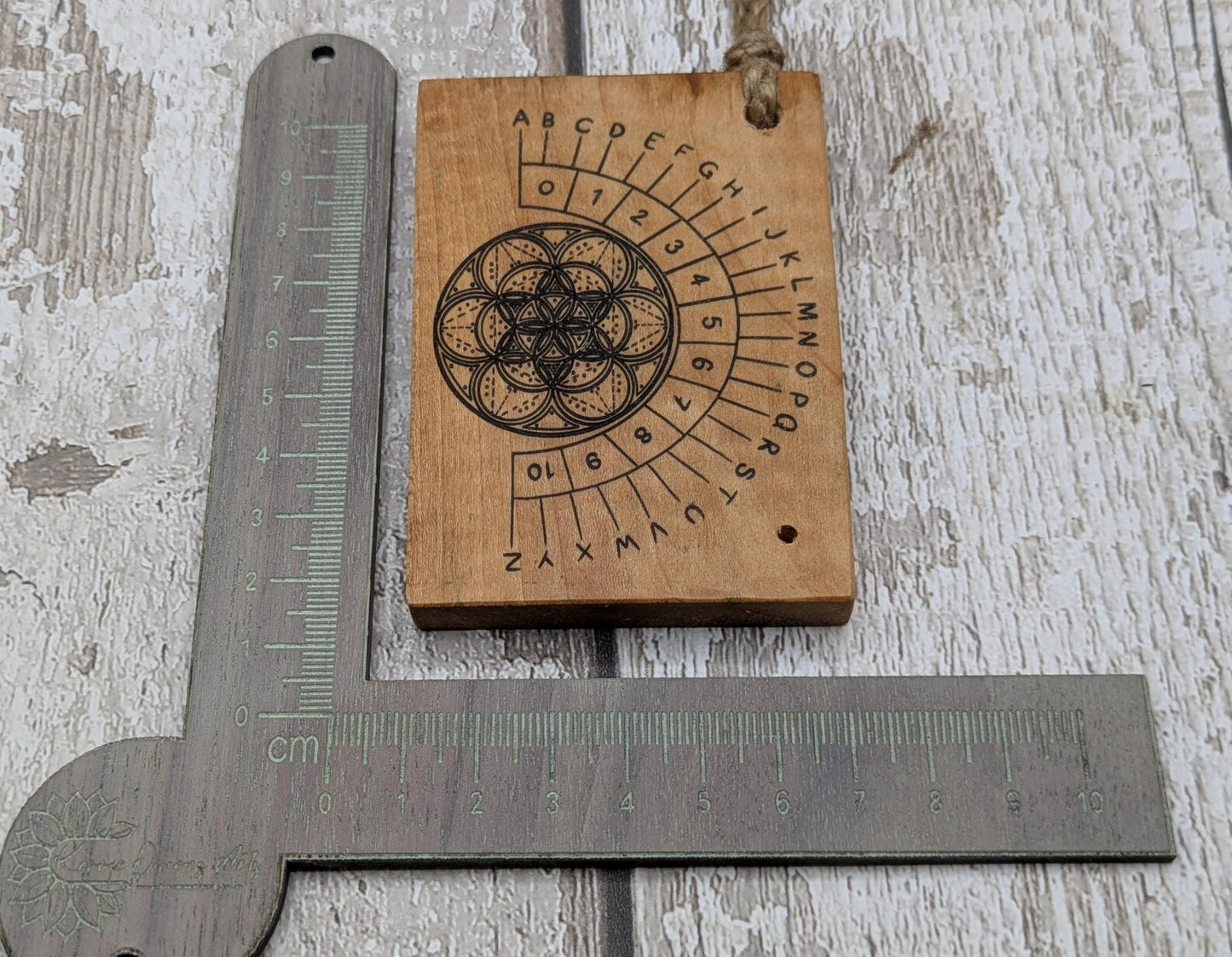 Alder wood mini pocket sized alphabet dowsing pendulum board.