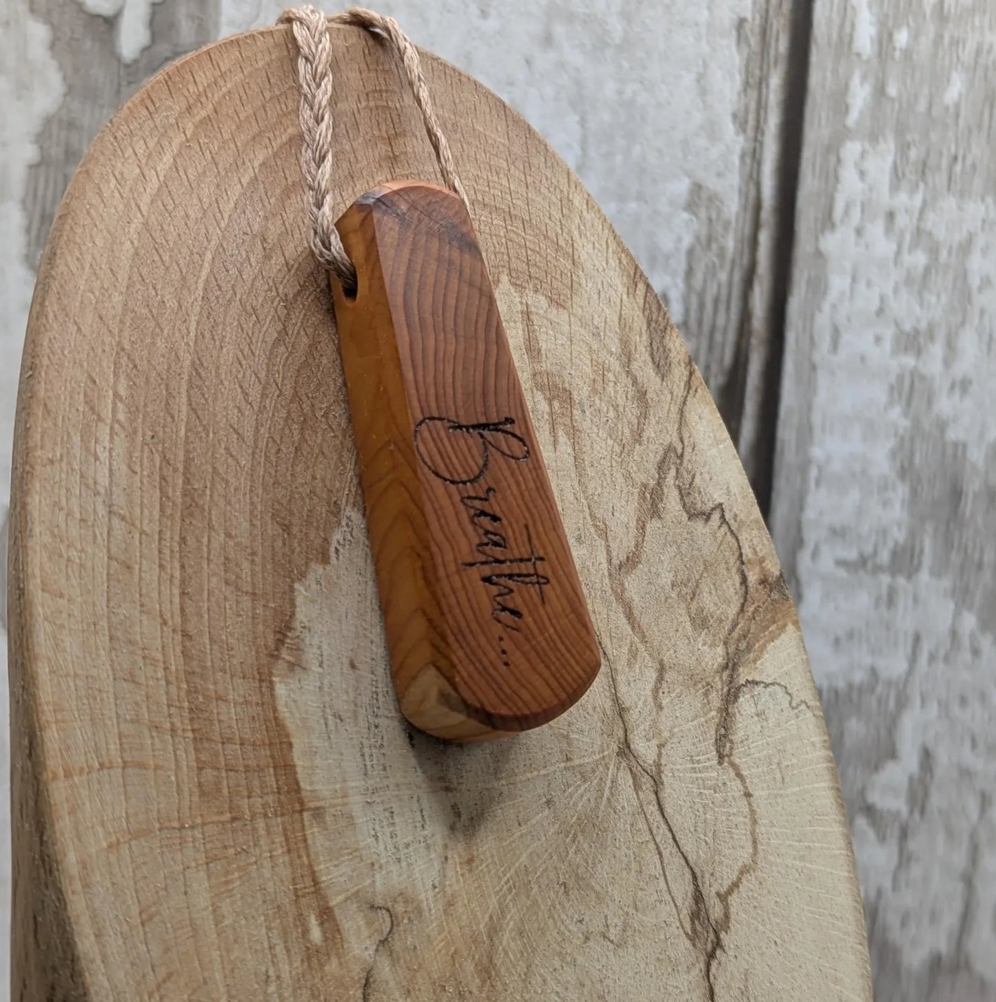 Yew wood laser engraved breathe tear drop pendant.