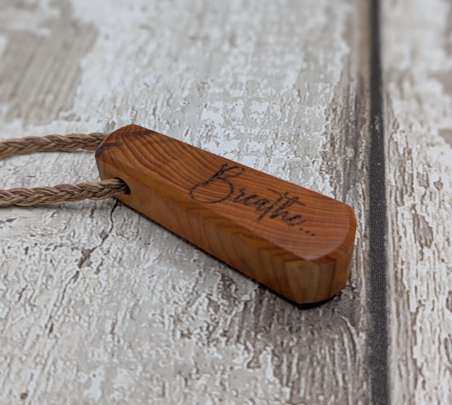 Yew wood laser engraved breathe tear drop pendant.