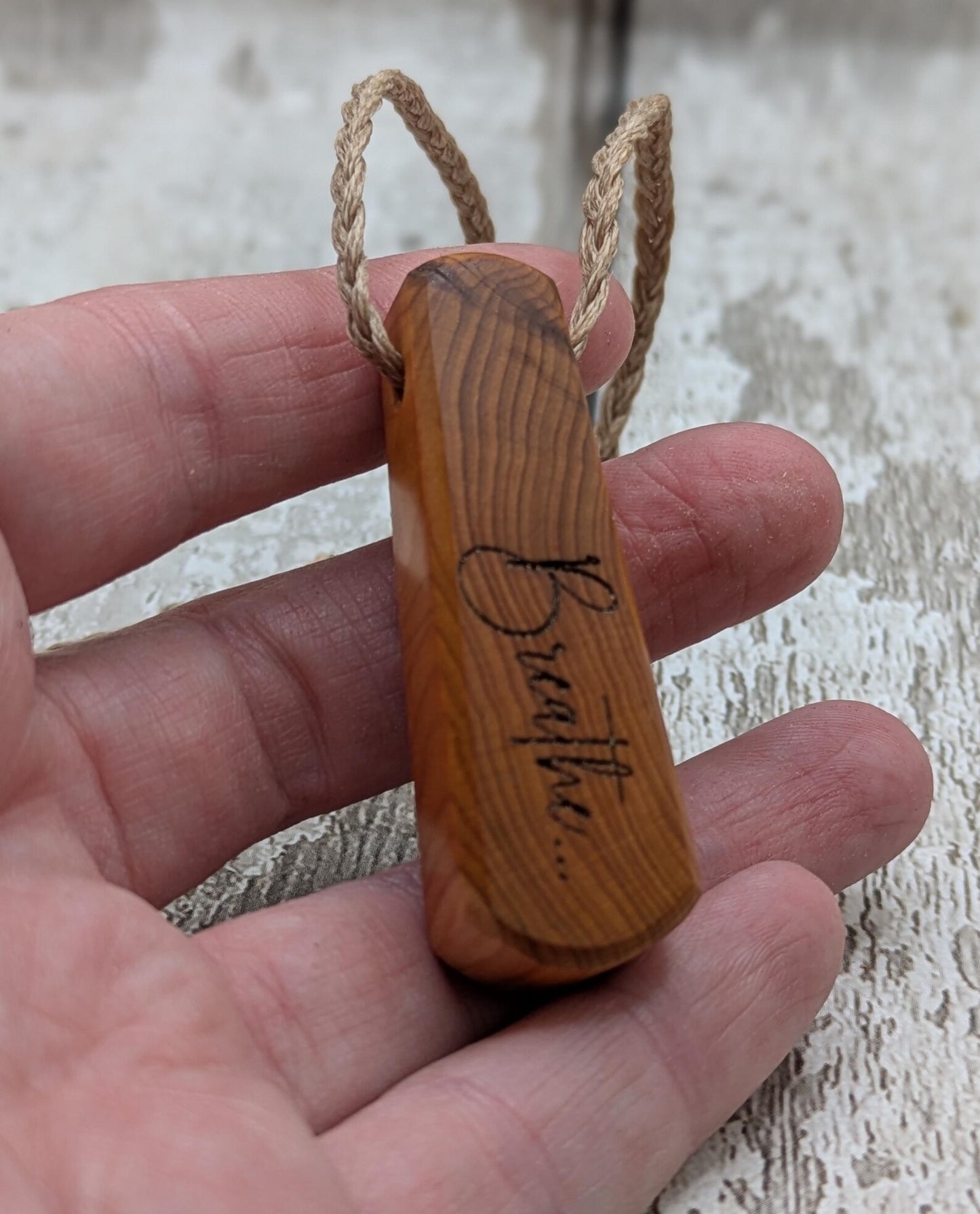 Yew wood laser engraved breathe tear drop pendant.