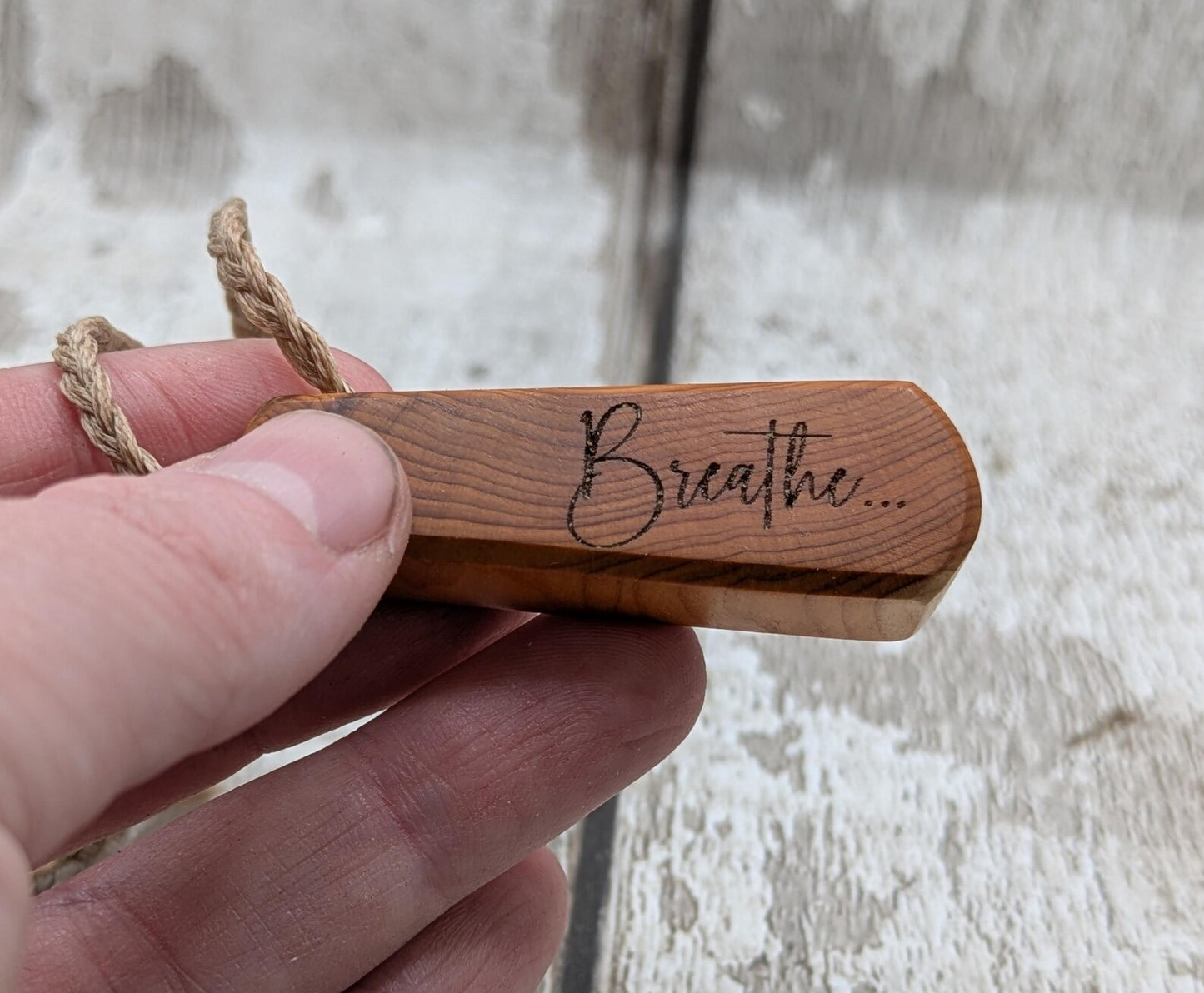 Yew wood laser engraved breathe tear drop pendant.