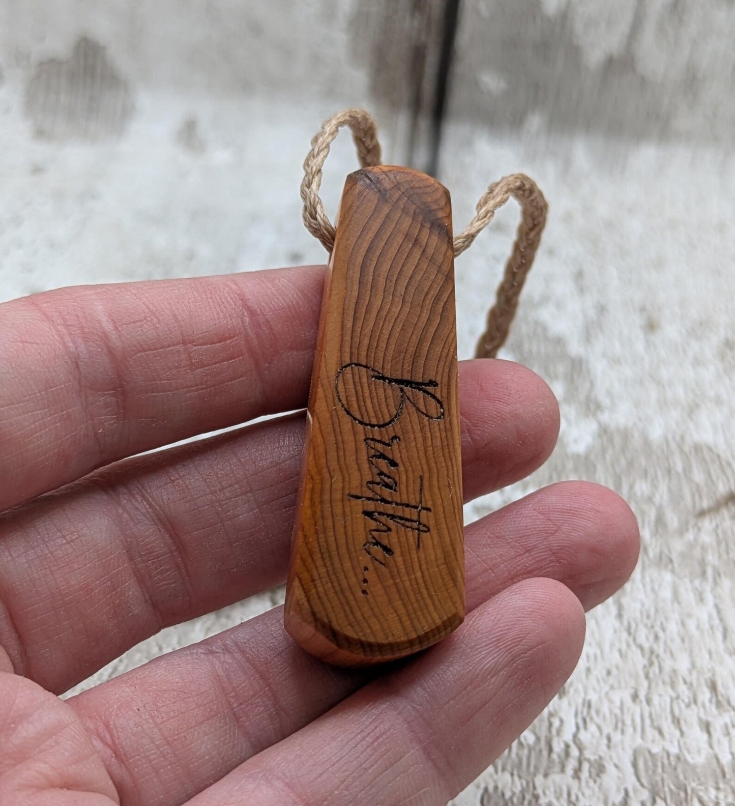 Yew wood laser engraved breathe tear drop pendant.