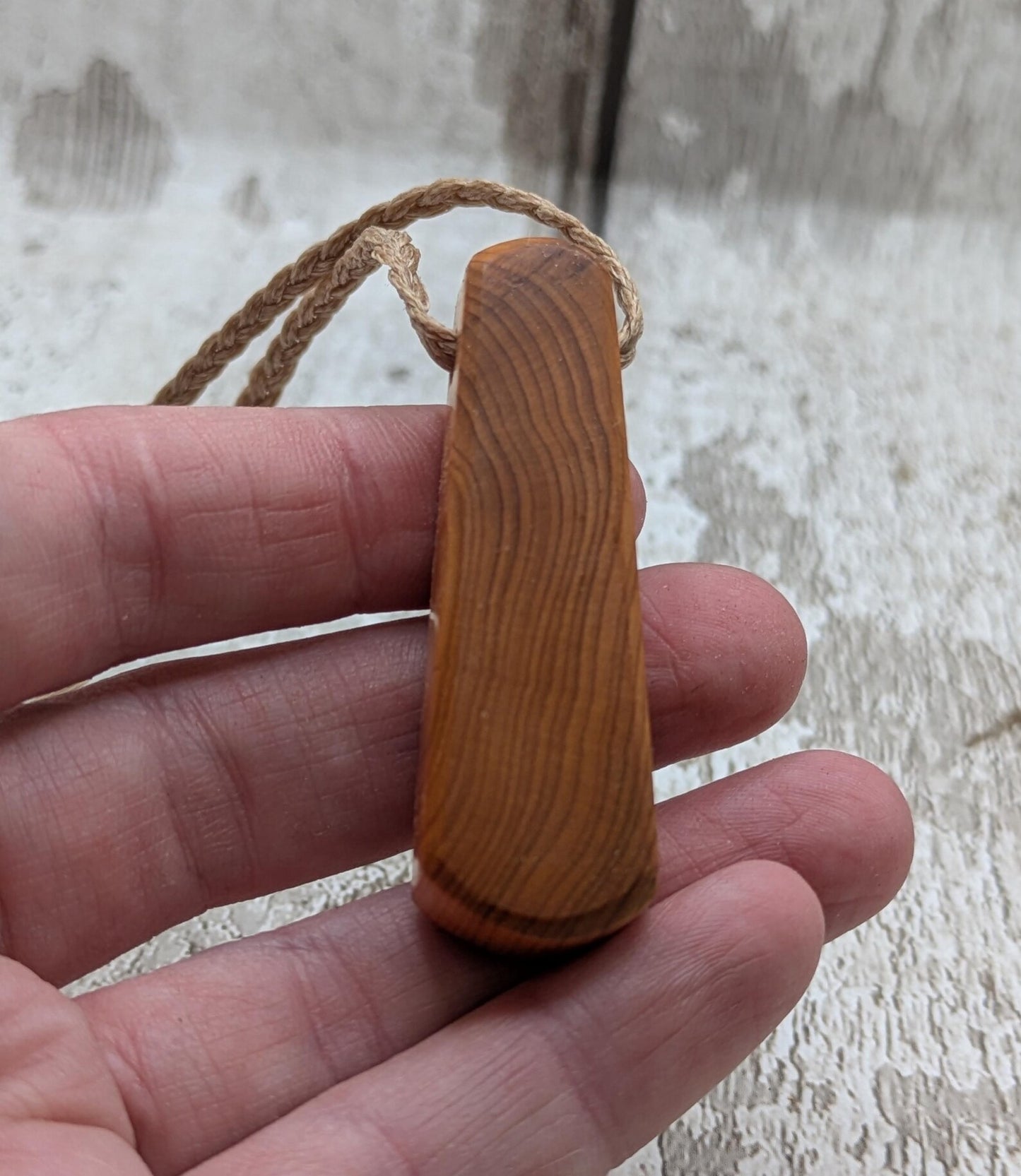 Yew wood laser engraved breathe tear drop pendant.