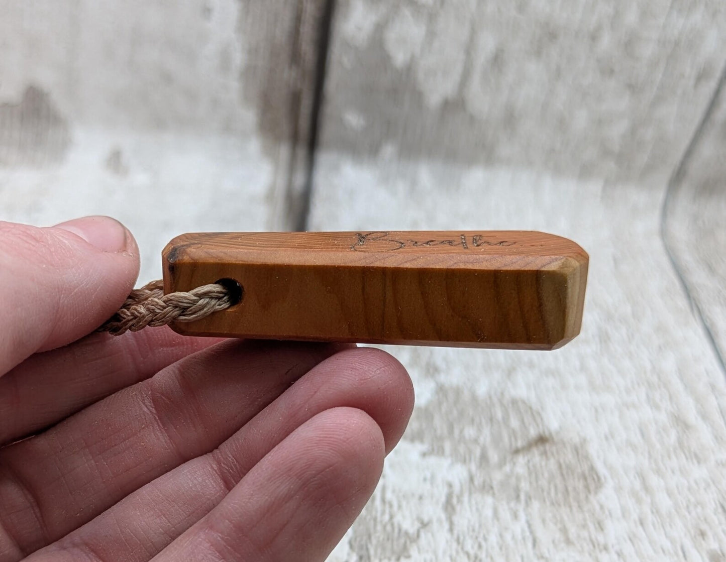 Yew wood laser engraved breathe tear drop pendant.
