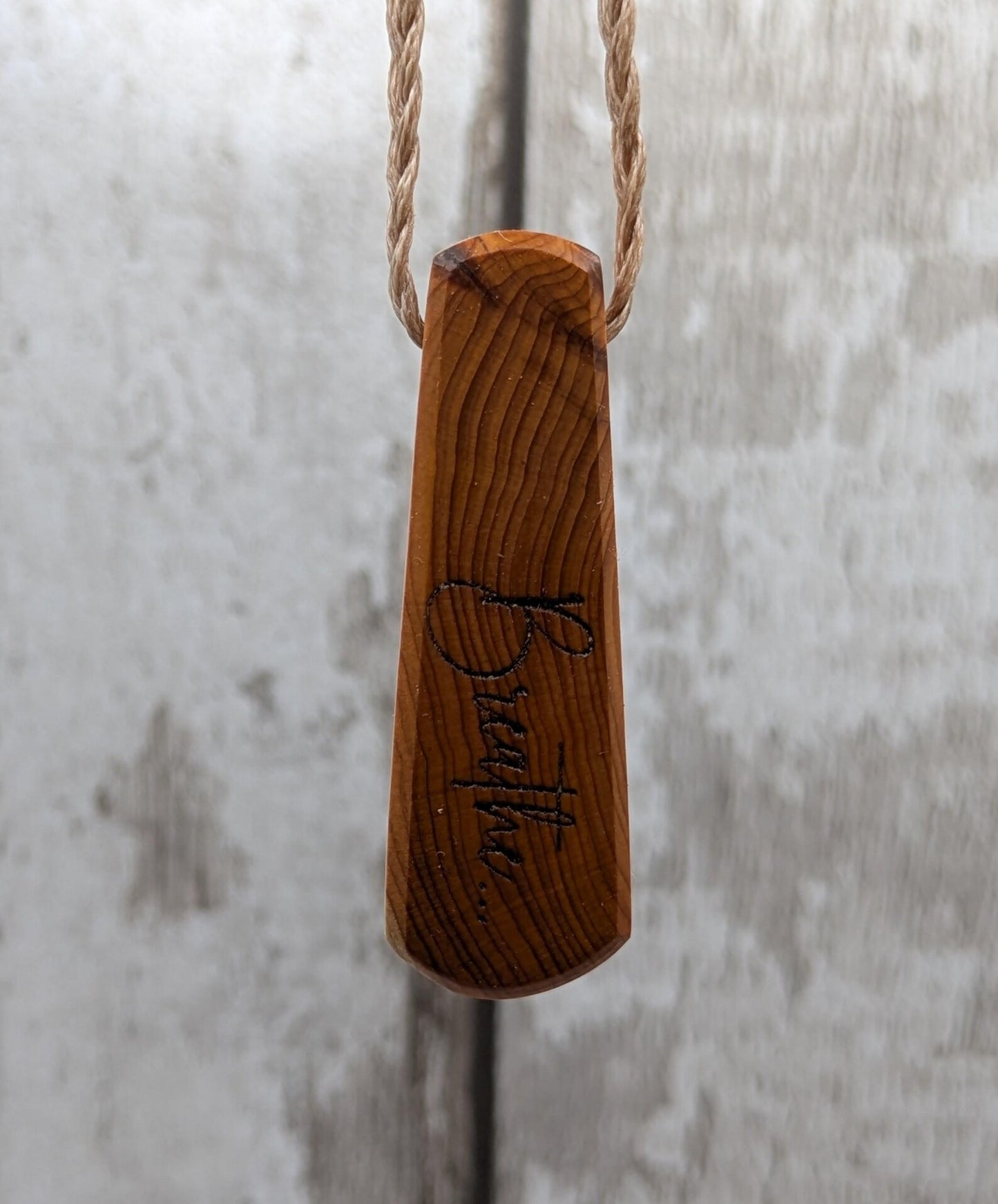Yew wood laser engraved breathe tear drop pendant.