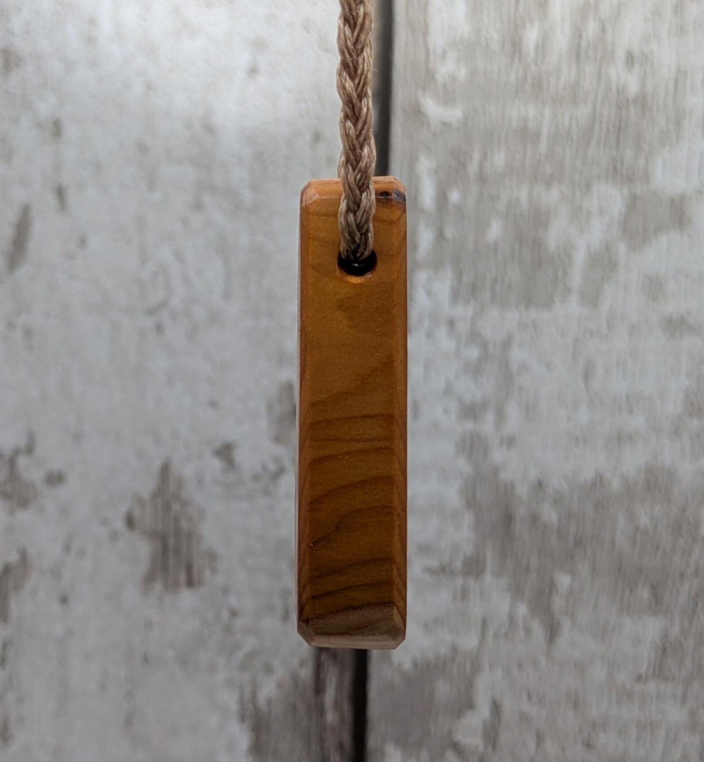 Yew wood laser engraved breathe tear drop pendant.