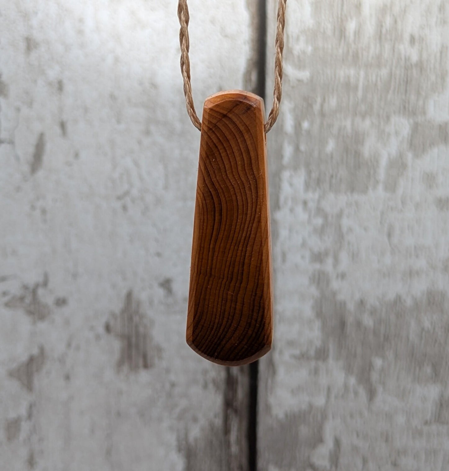 Yew wood laser engraved breathe tear drop pendant.