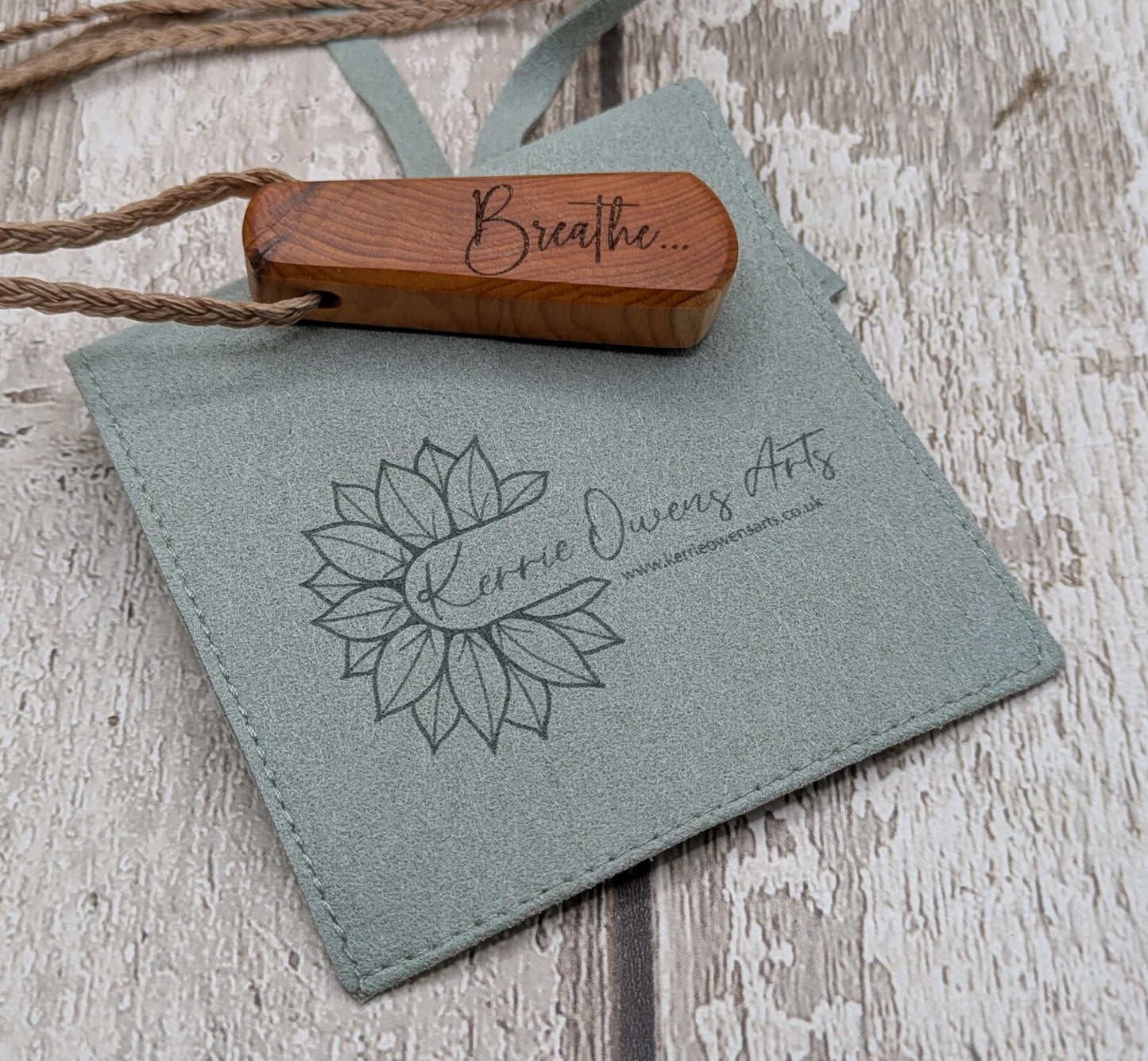 Yew wood laser engraved breathe tear drop pendant.