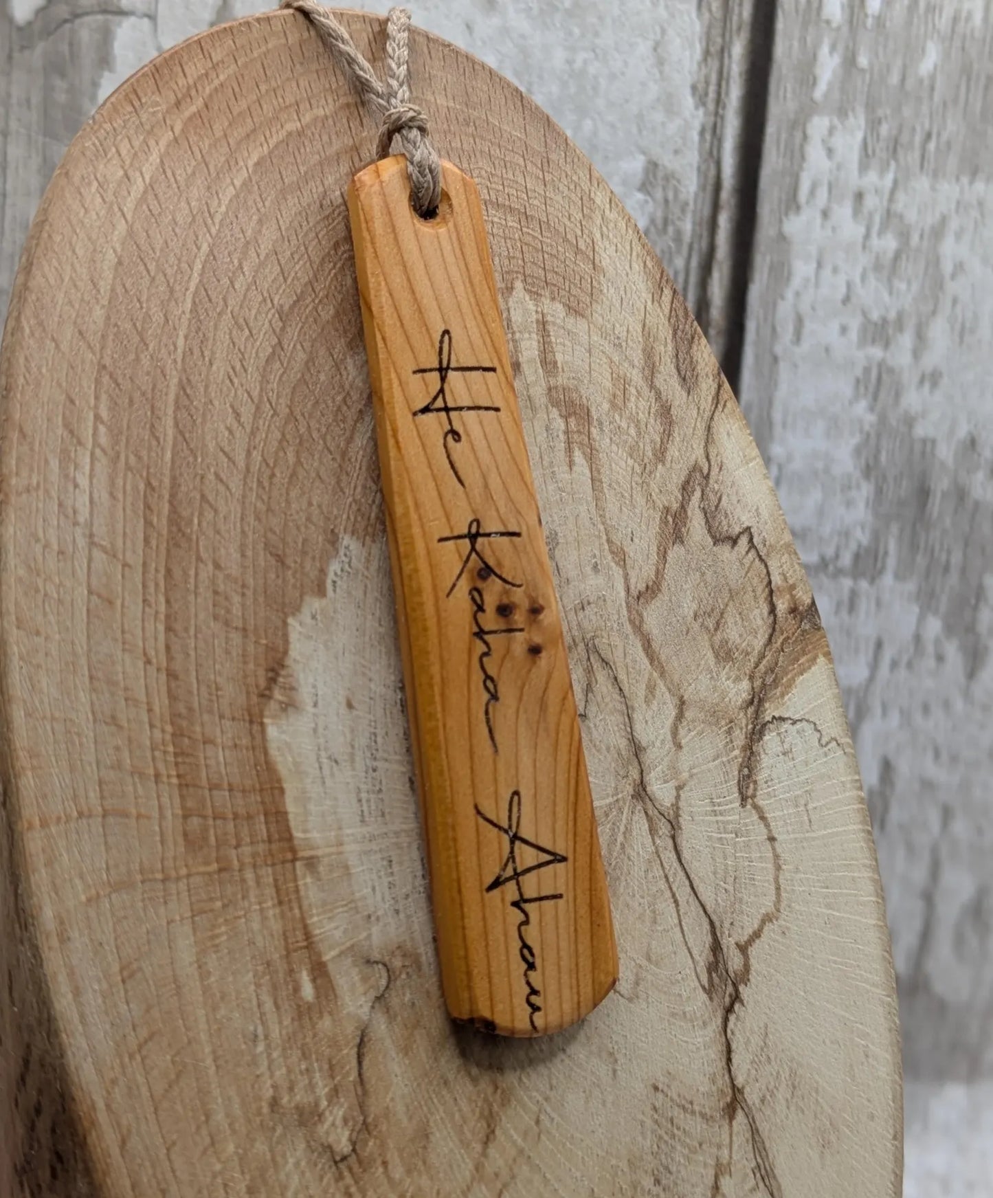 Yew wood roimata pendant with te reo māori He kaha ahau, I am strong.