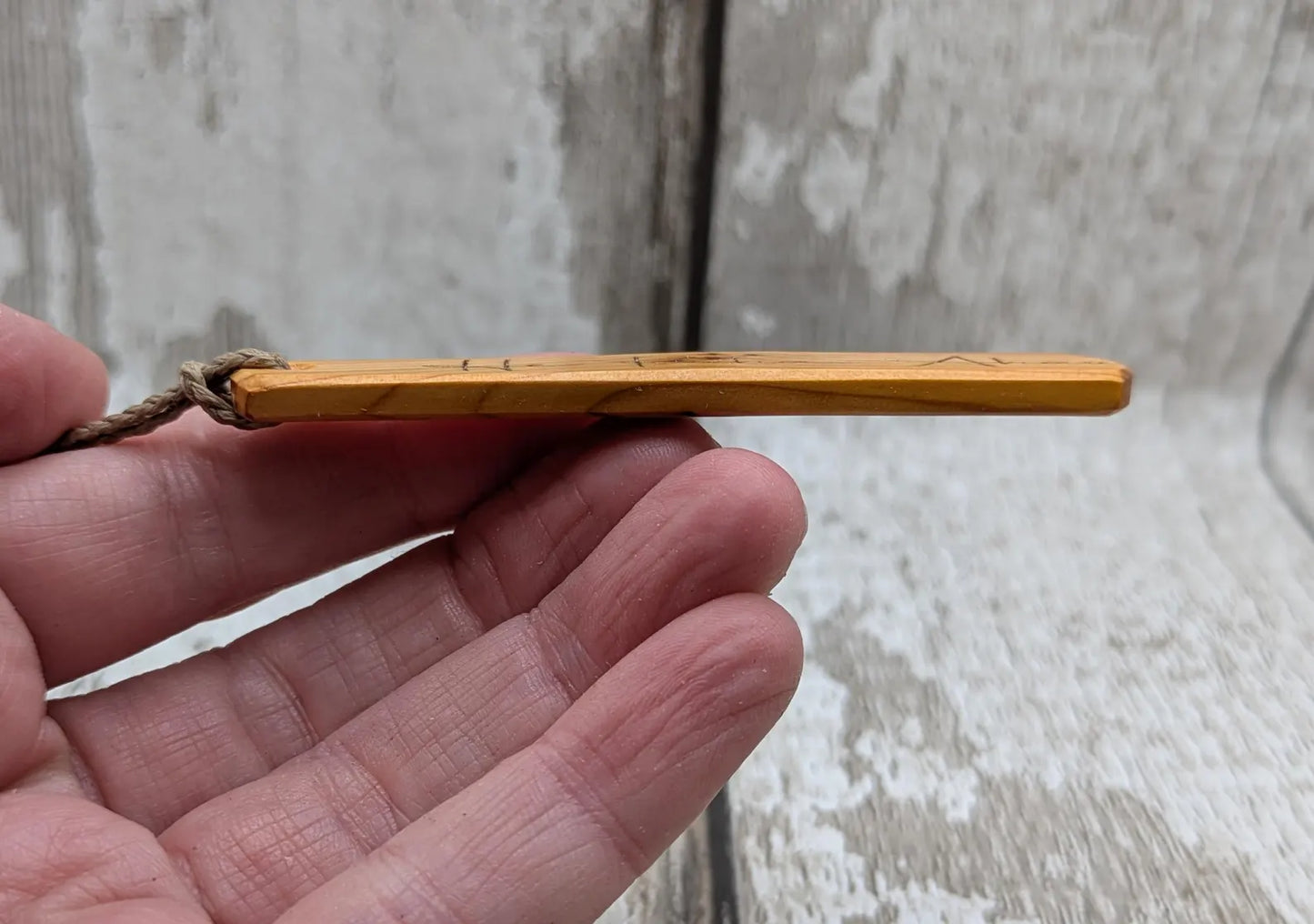 Yew wood roimata pendant with te reo māori He kaha ahau, I am strong.