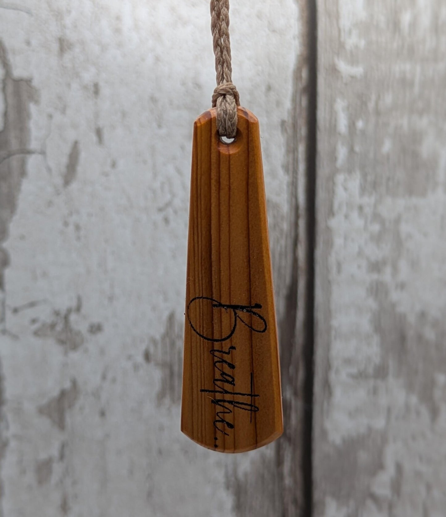 Yew wood roimata drop pendant with breathe mantra laser print.