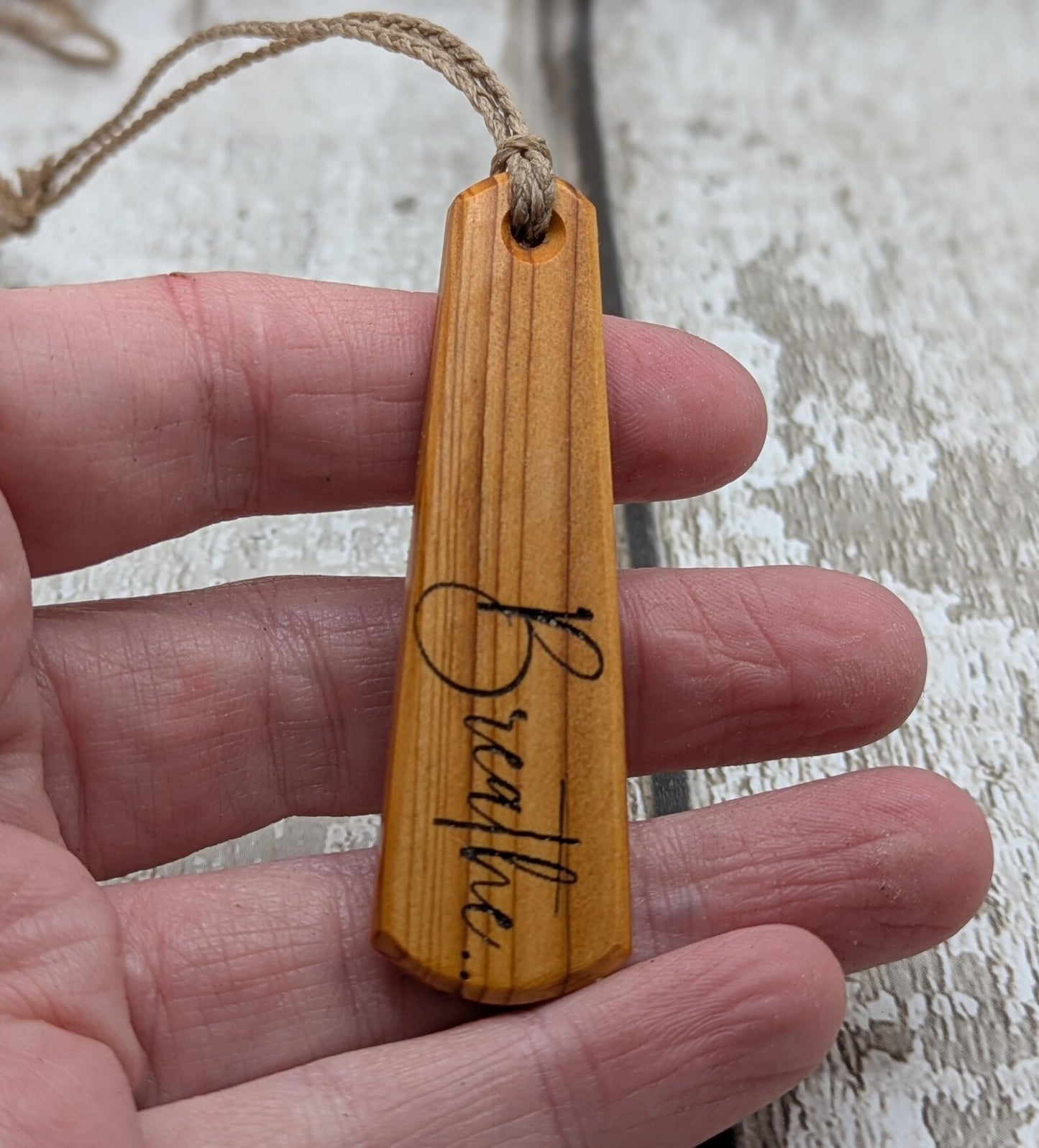 Yew wood roimata drop pendant with breathe mantra laser print.