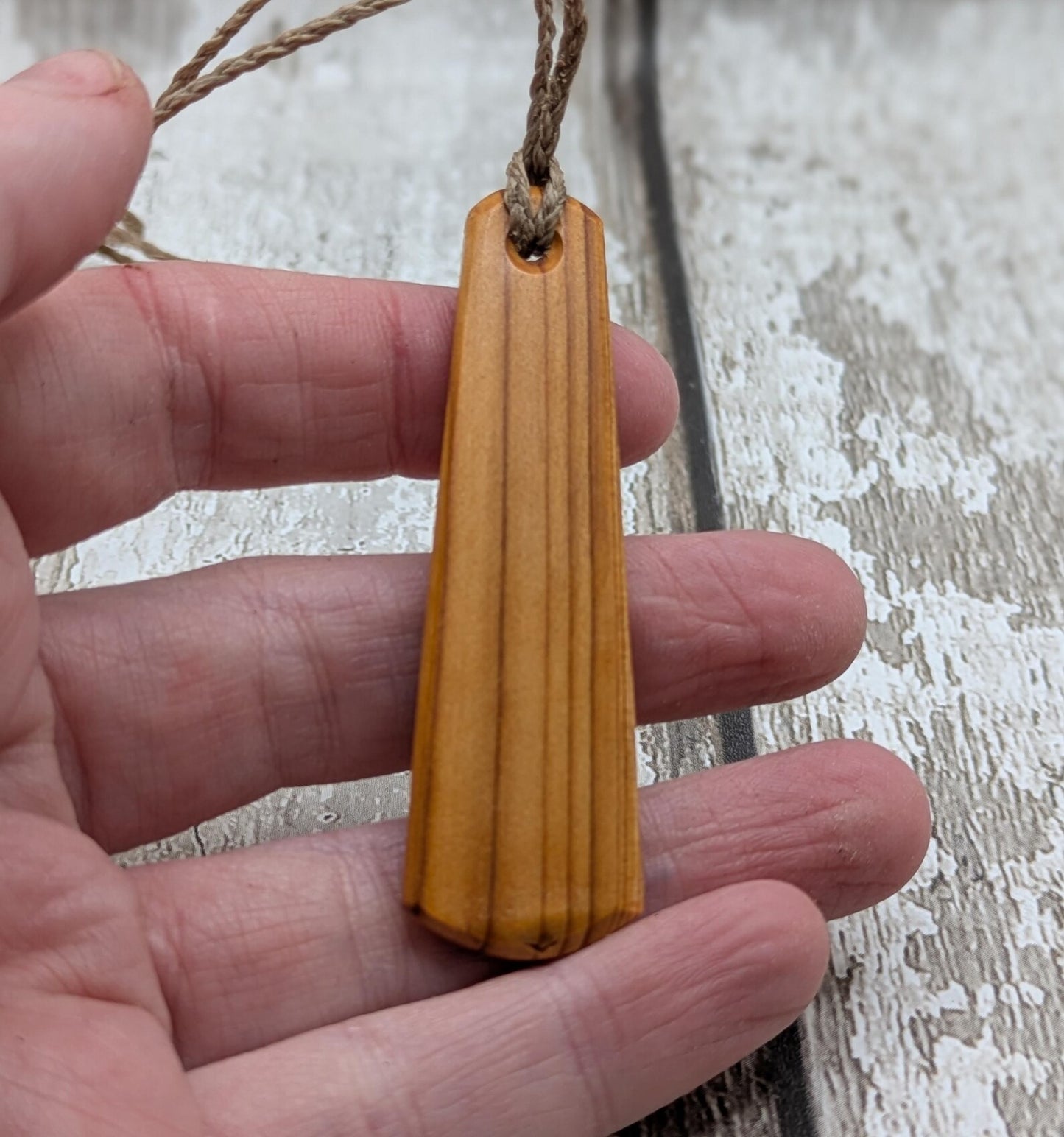 Yew wood roimata drop pendant with breathe mantra laser print.