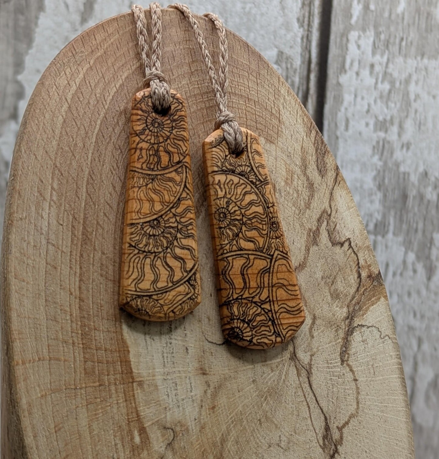 One Yew wood ammonite laser printed tear drop pendant.