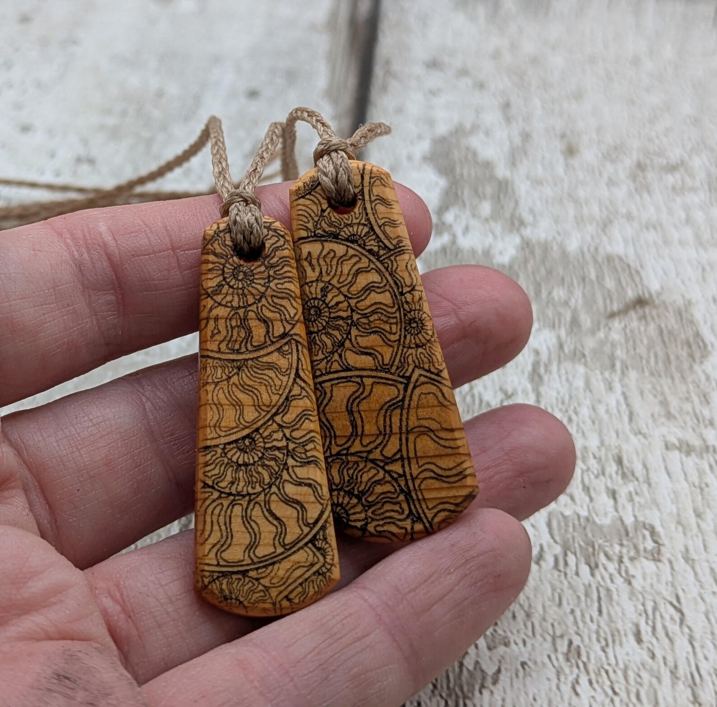 One Yew wood ammonite laser printed tear drop pendant.