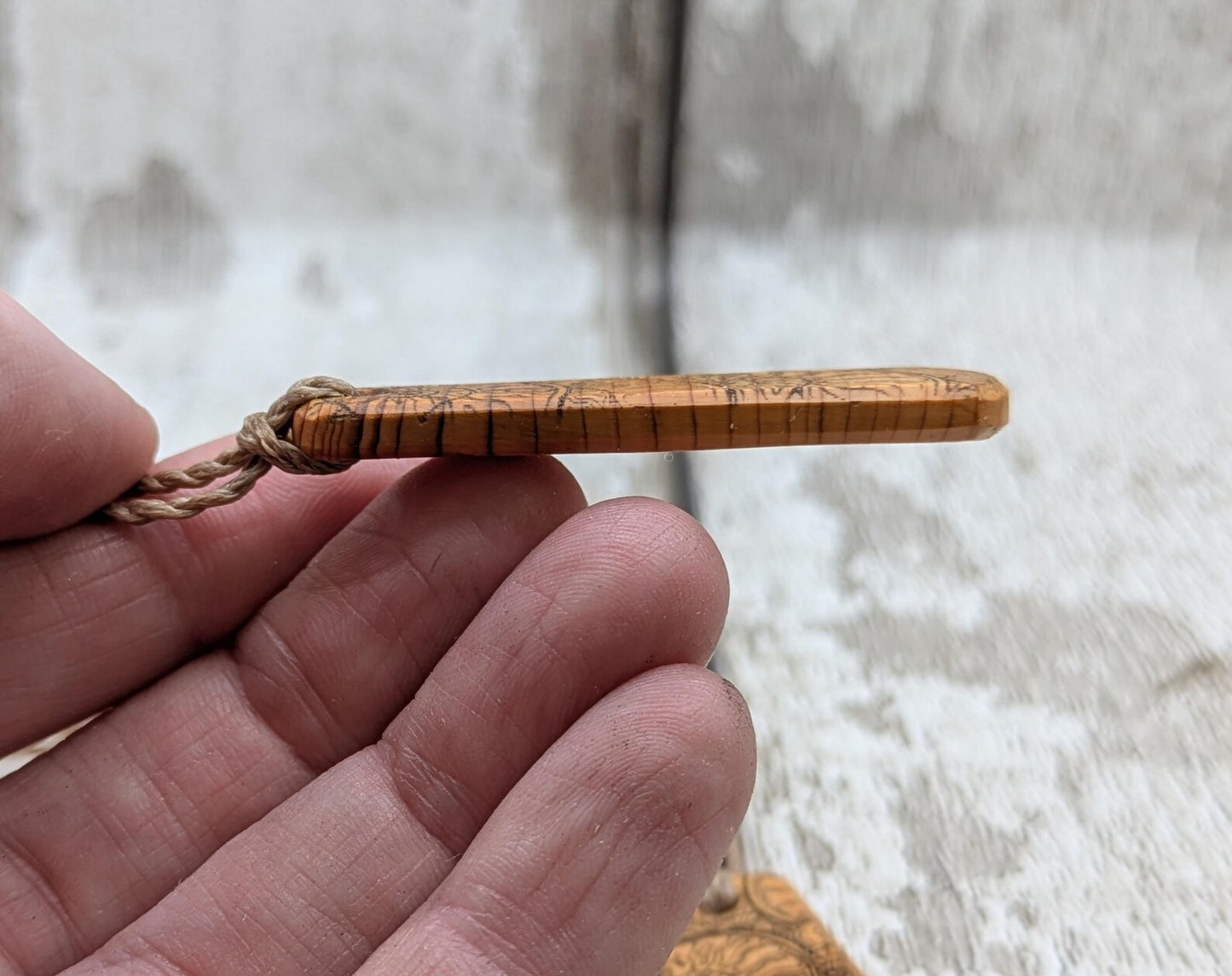 One Yew wood ammonite laser printed tear drop pendant.