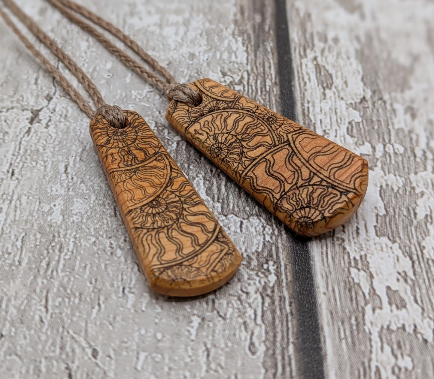 One Yew wood ammonite laser printed tear drop pendant.