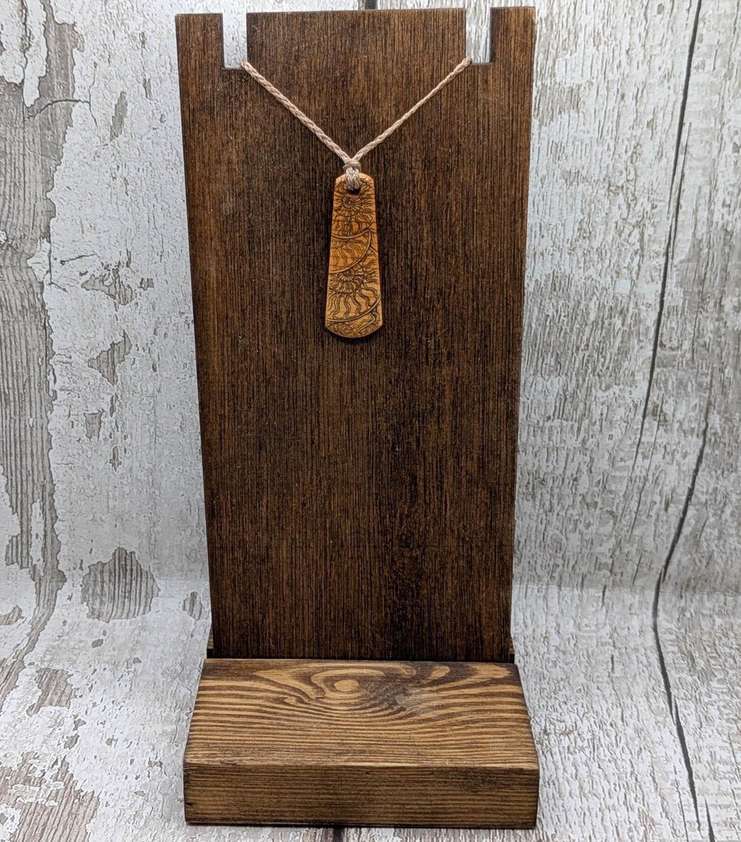 One Yew wood ammonite laser printed tear drop pendant.
