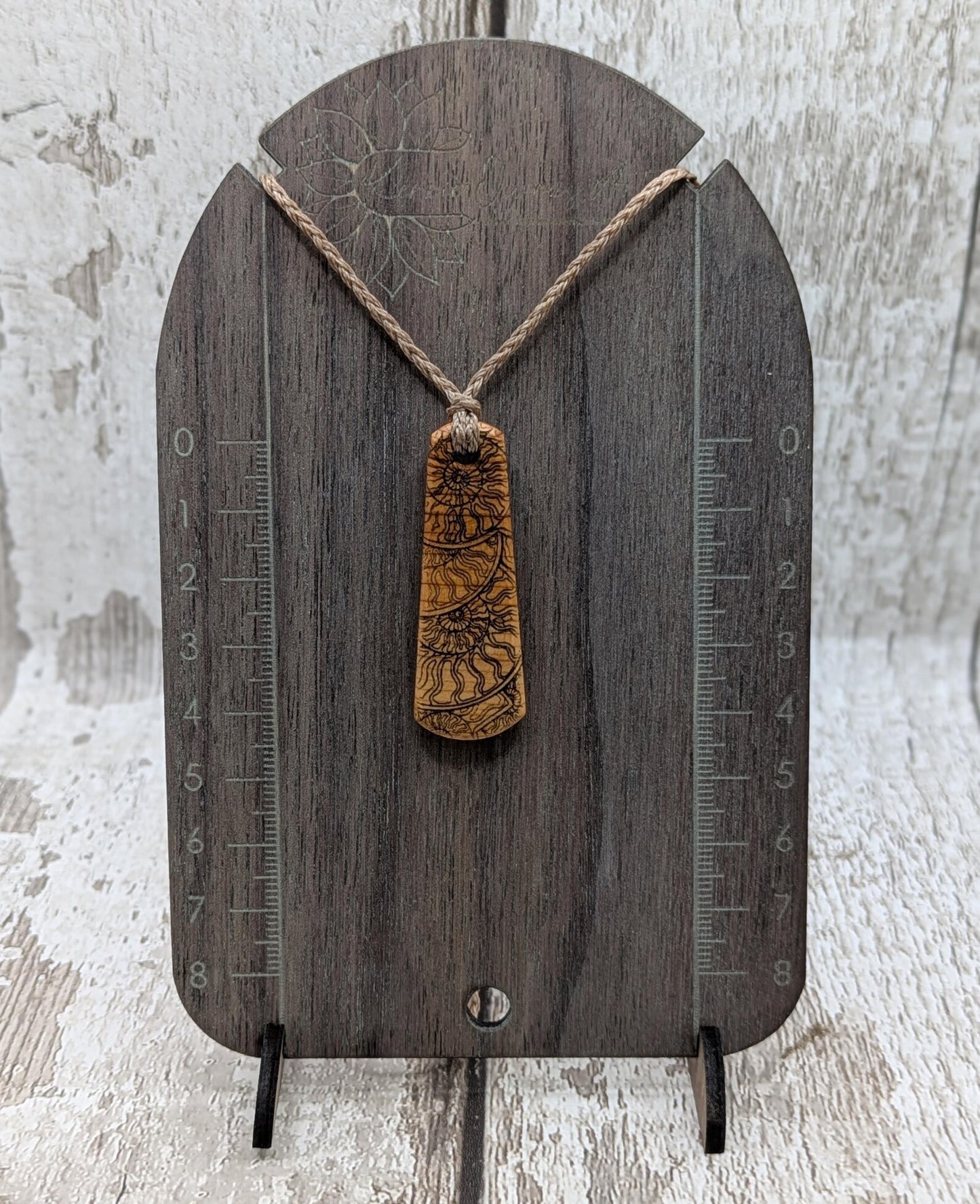 One Yew wood ammonite laser printed tear drop pendant.