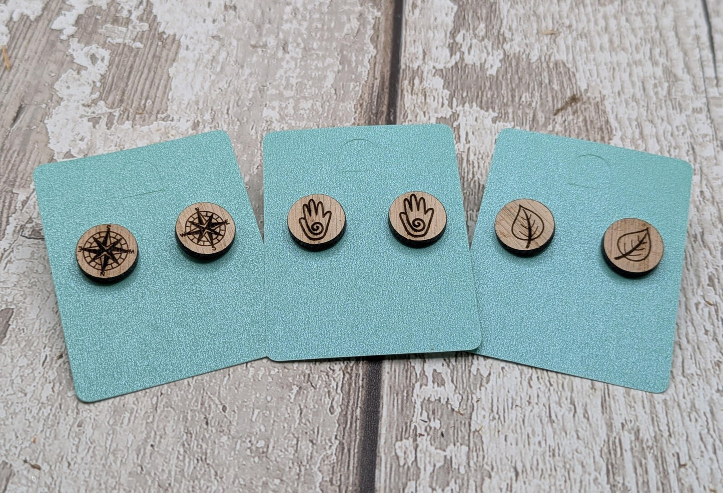 Sweet chestnut compass stud earrings with stainless steel findings.