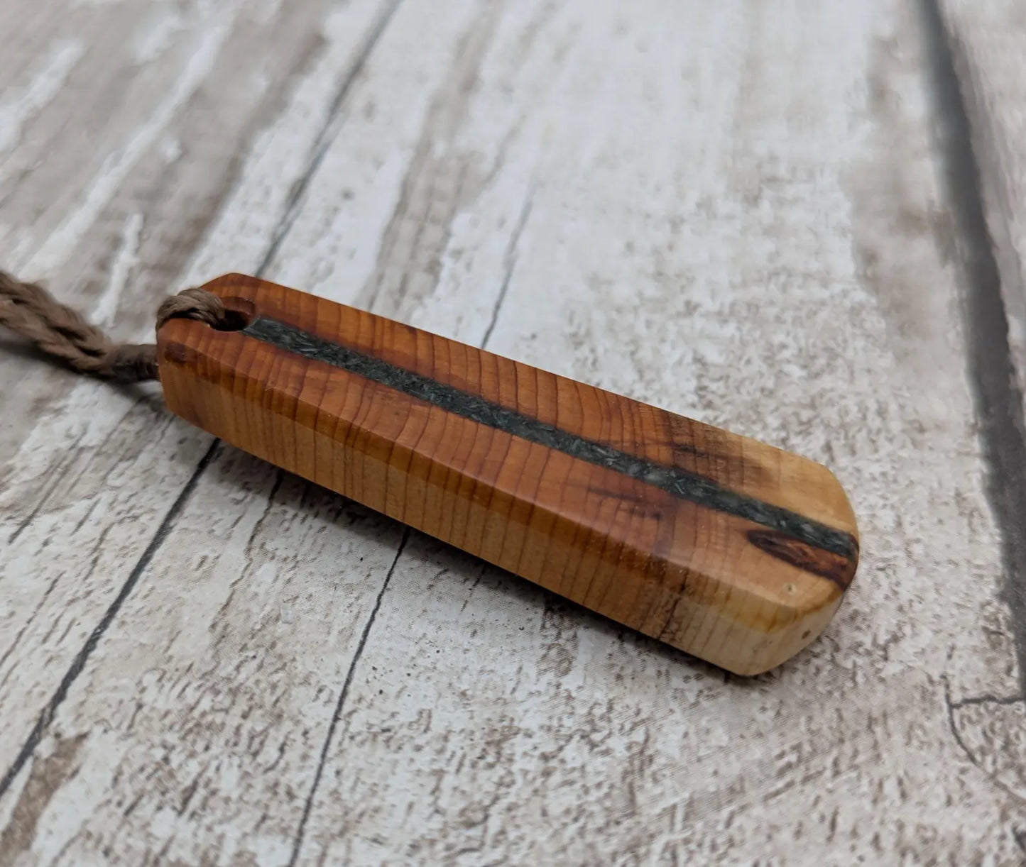 Yew wood roimata drop pendant with Aotea inlay.