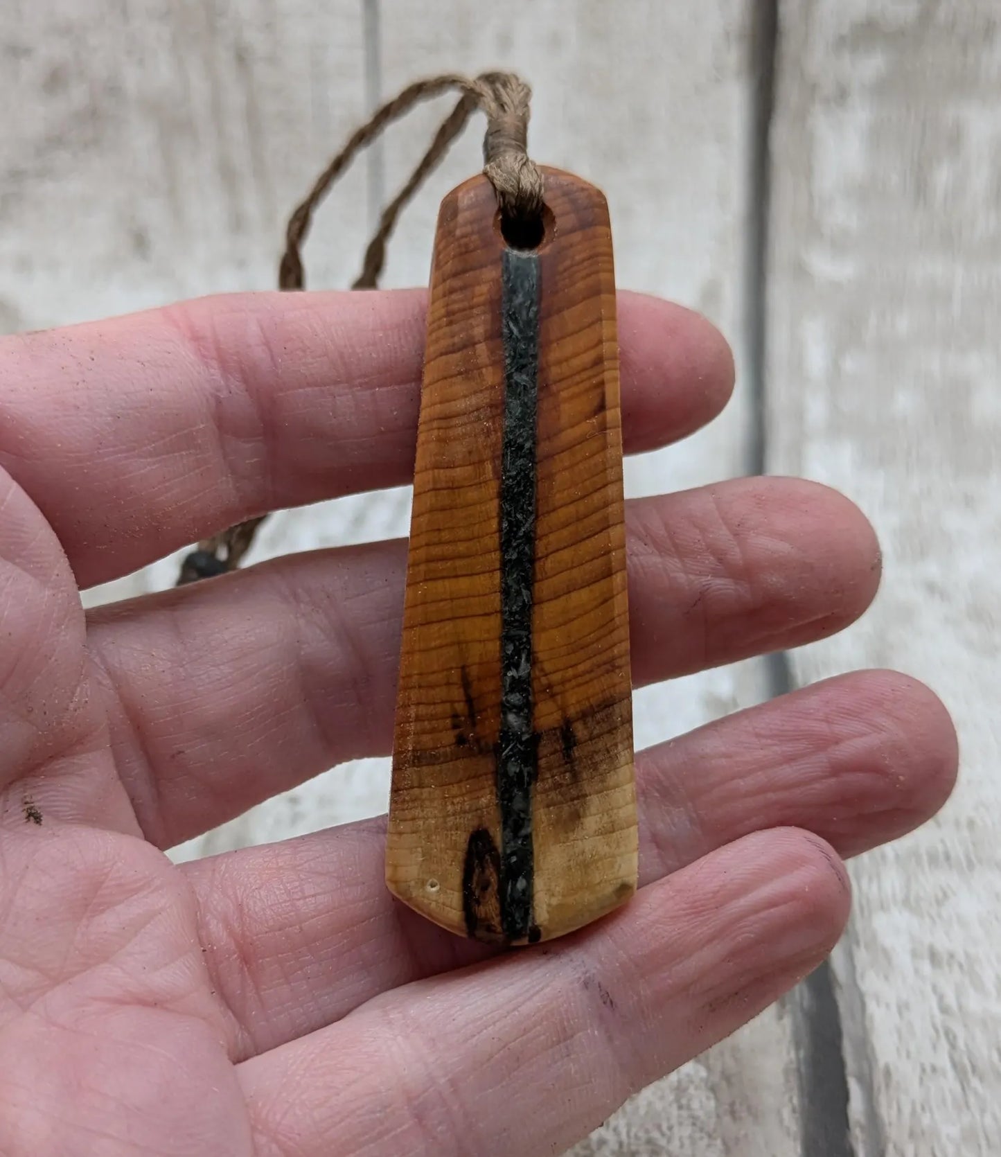 Yew wood roimata drop pendant with Aotea inlay.