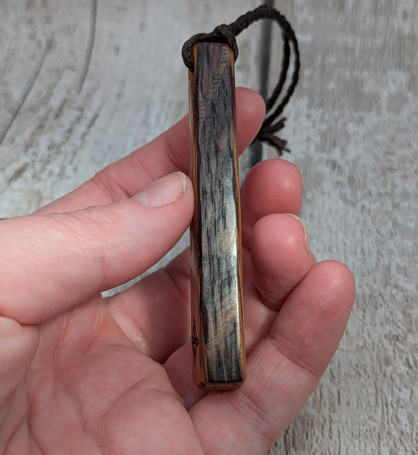 Whiskey barrel oak tear drop pendant with laser printed with rune symbol.