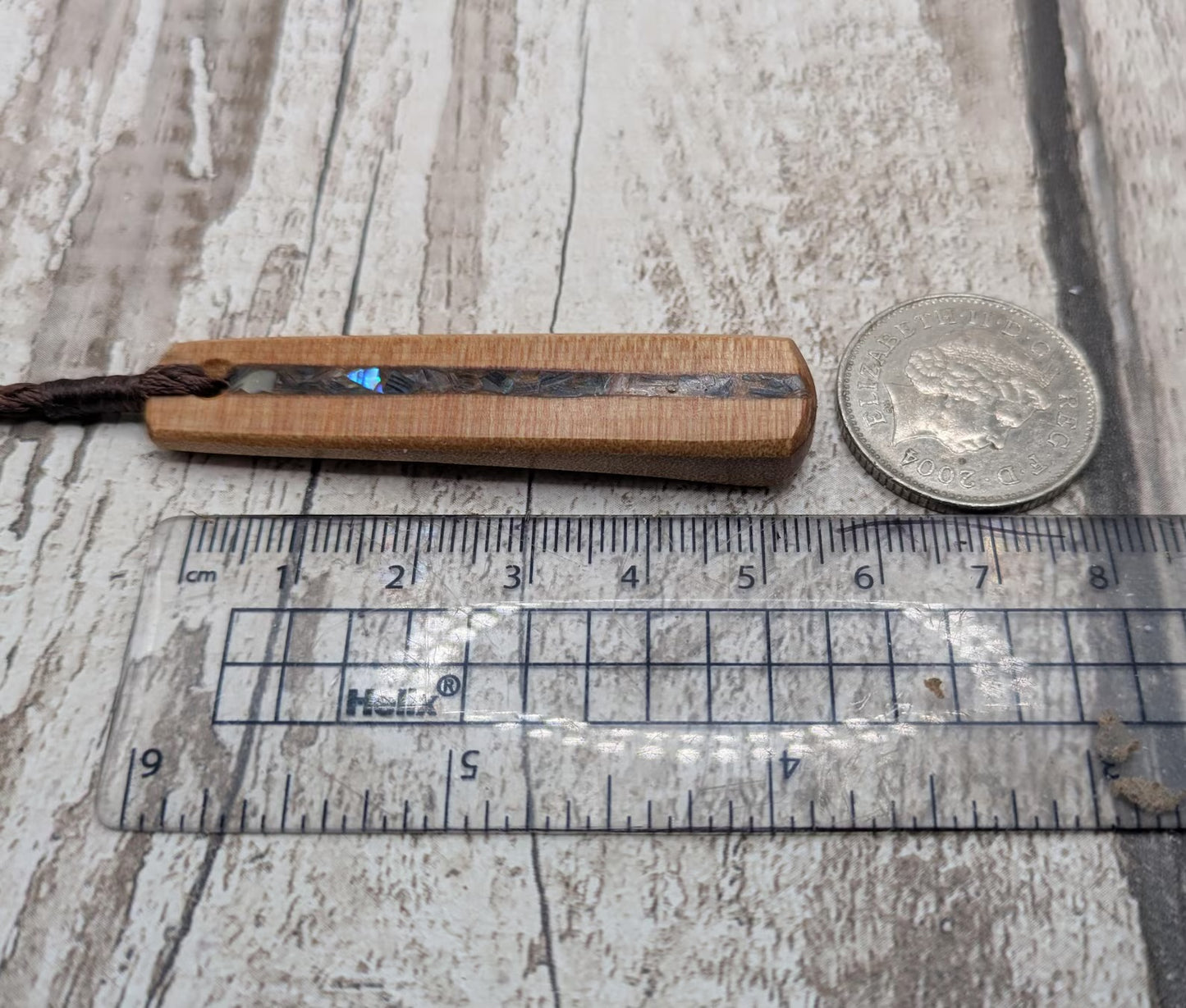NZ Swamp Kauri wood pendant with rainbow pāua shell.